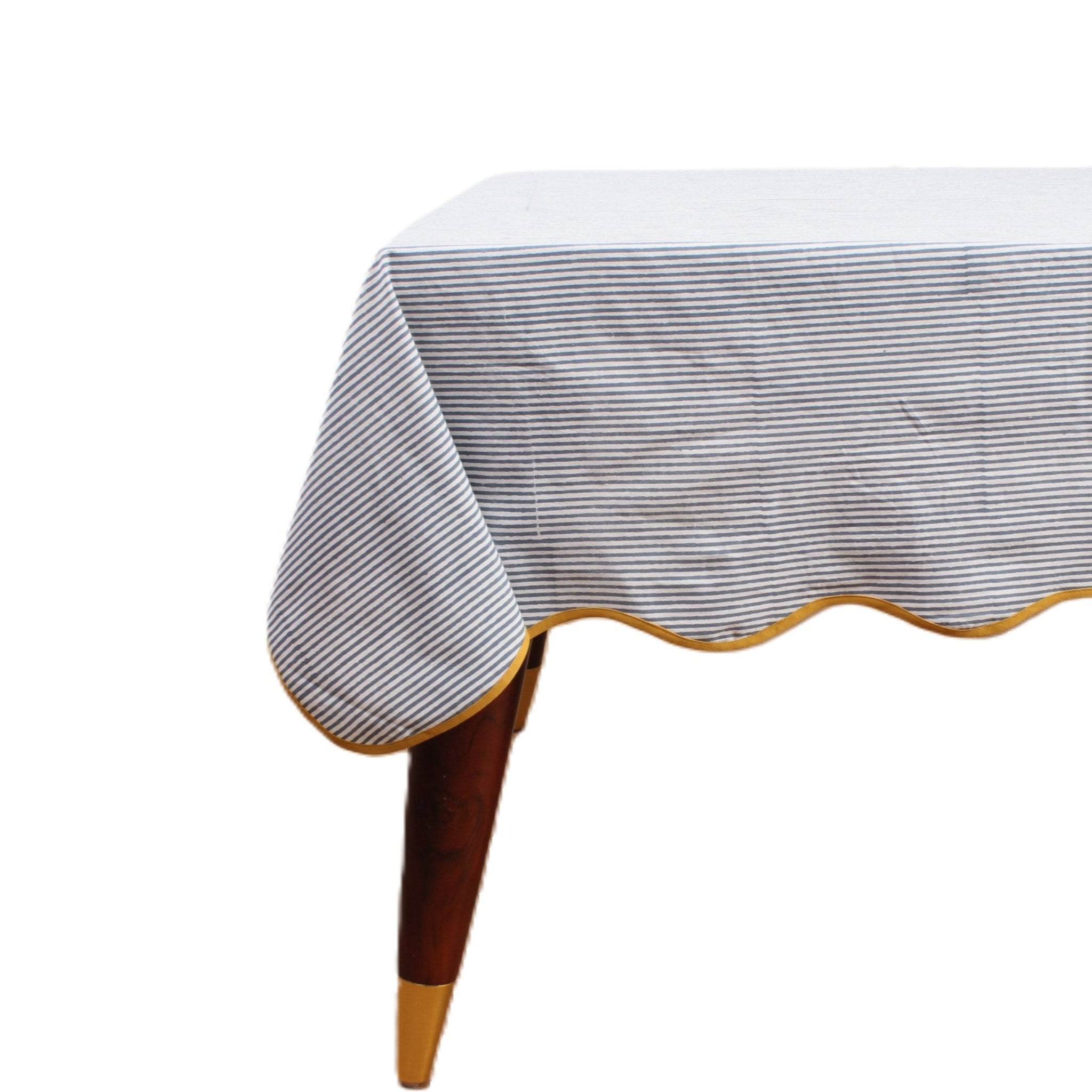 Table with a striped tablecloth on a white background