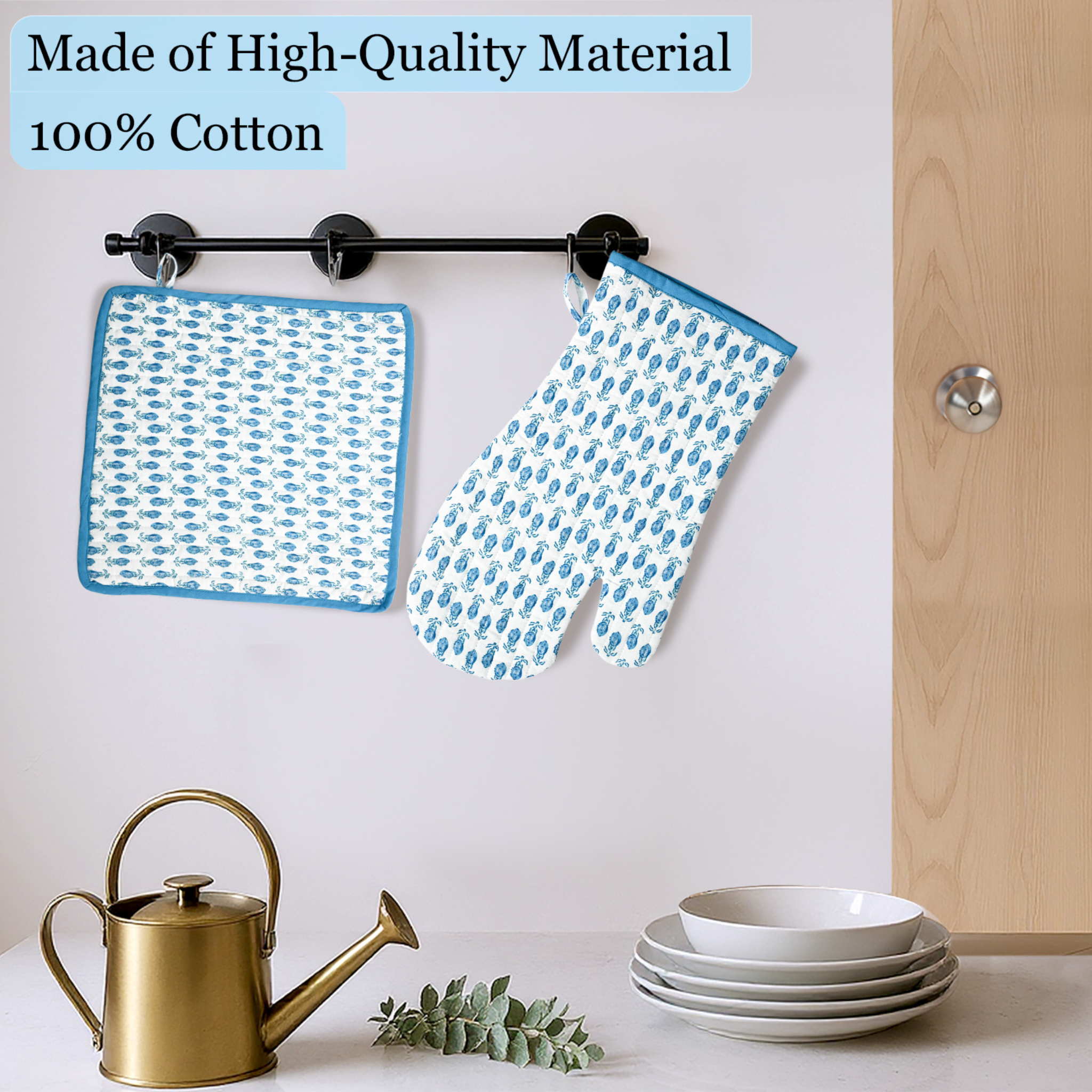 Blue patterned pot holder and oven mitt hanging on a rack with kitchen items below.