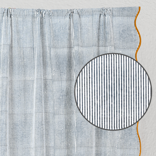 Textured fabric with a circular cutout and orange thread on a light gray background