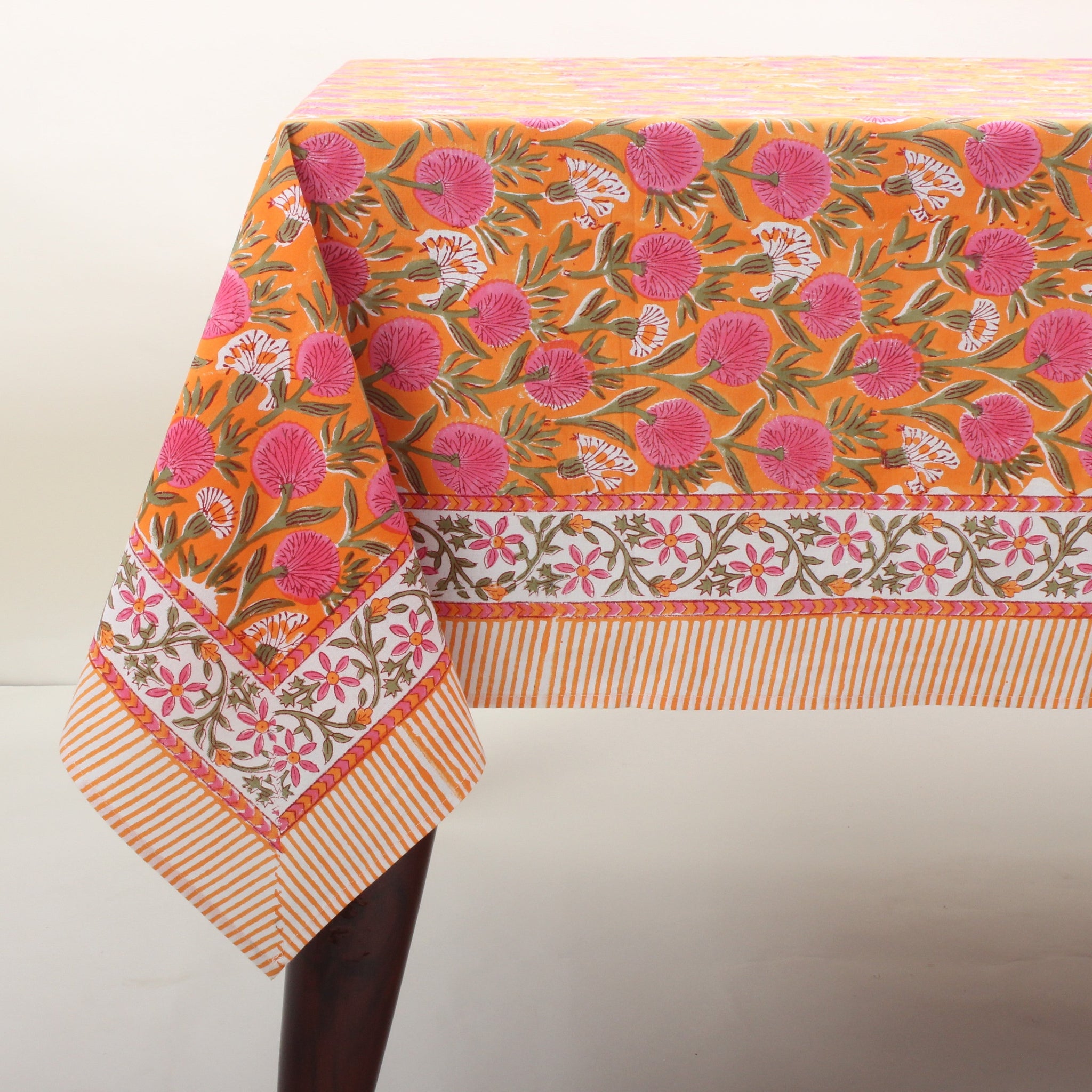 Floral patterned tablecloth on a table with a white background