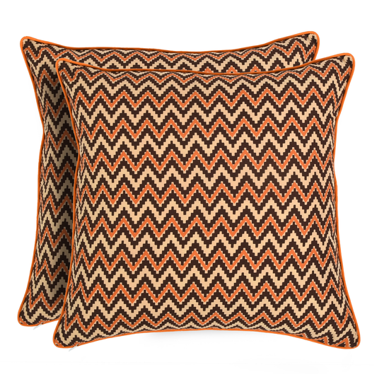 Two decorative pillows with a zigzag pattern on a white background