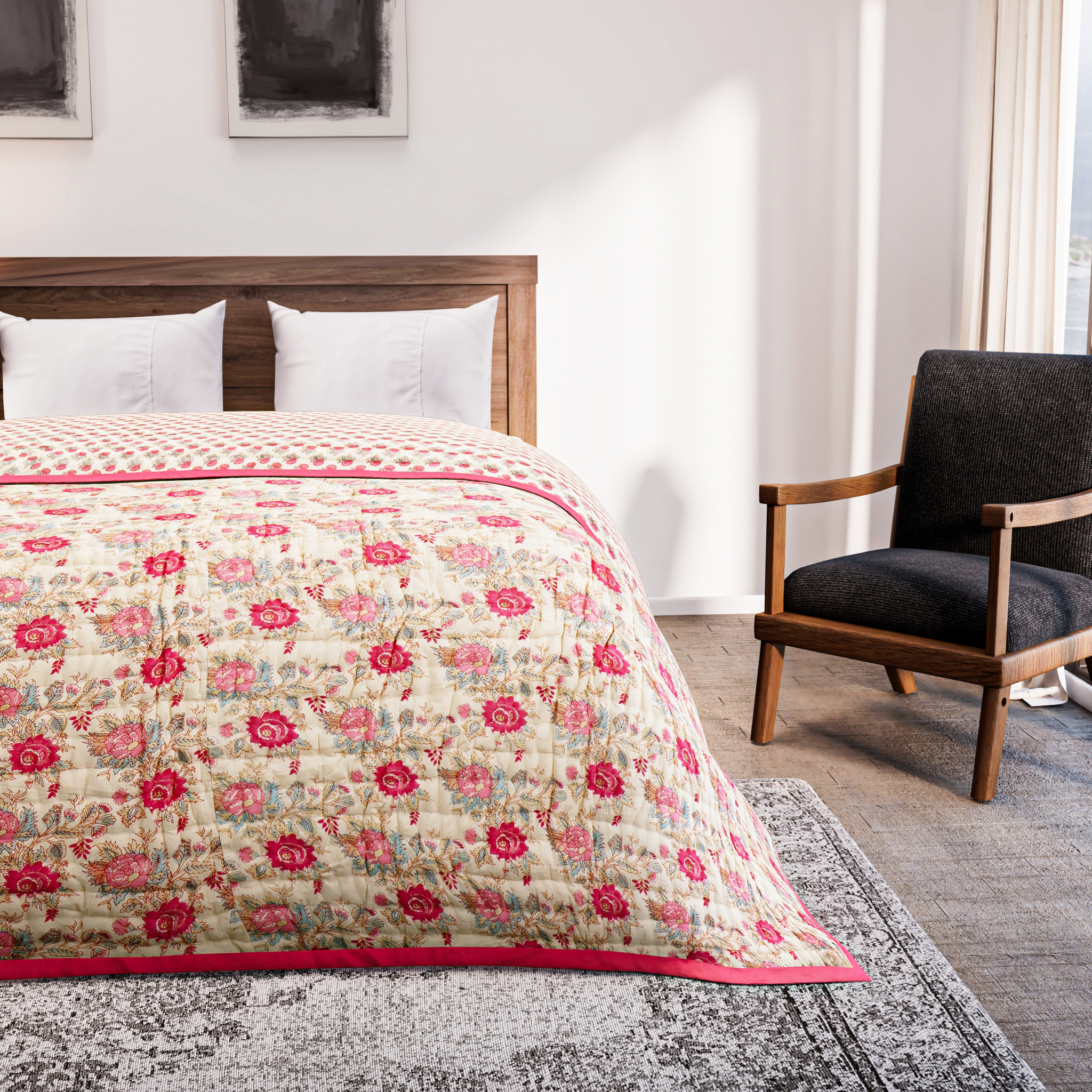 Bedroom with floral quilt on bed and armchair against wall