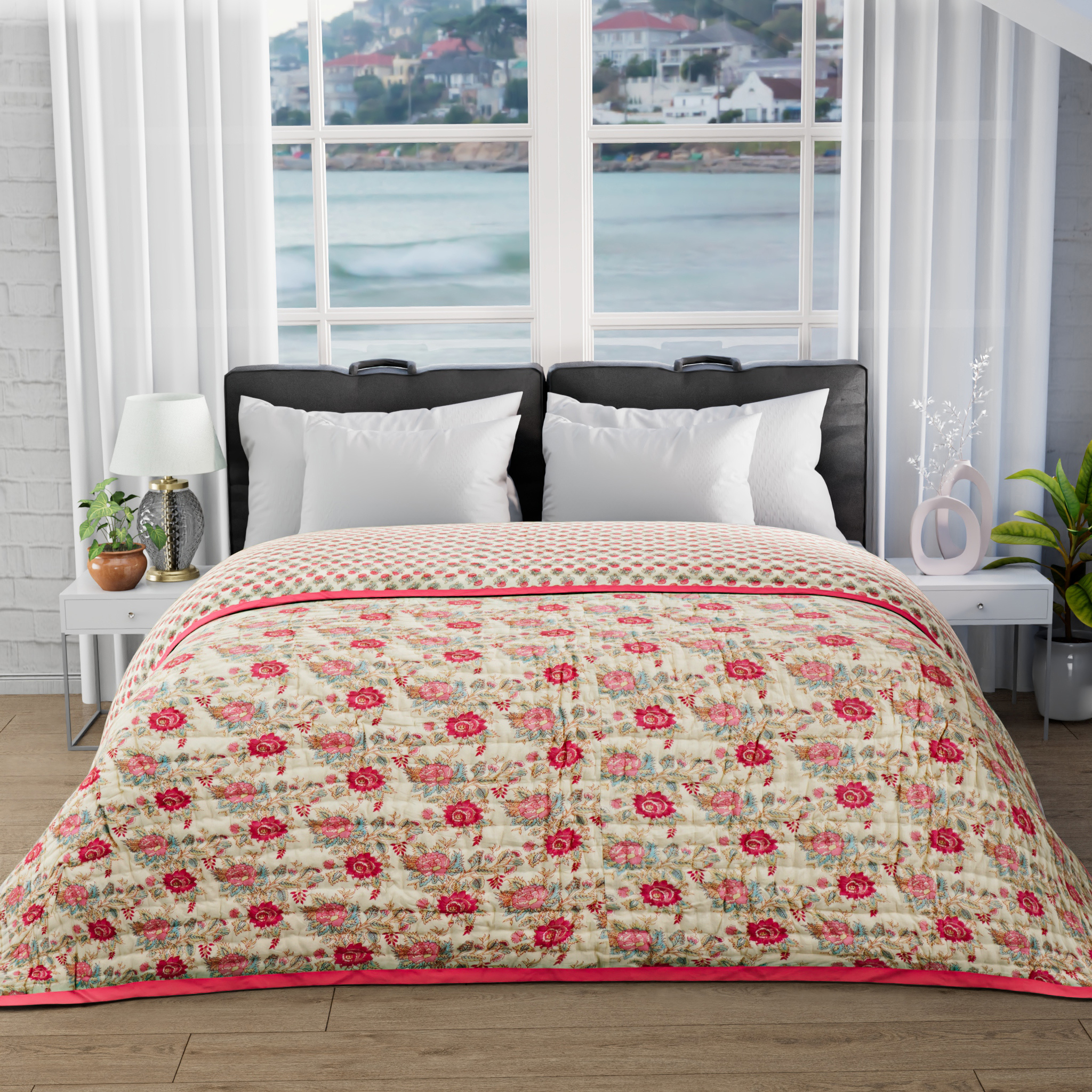 Floral quilt on a bed with a window view of water and buildings
