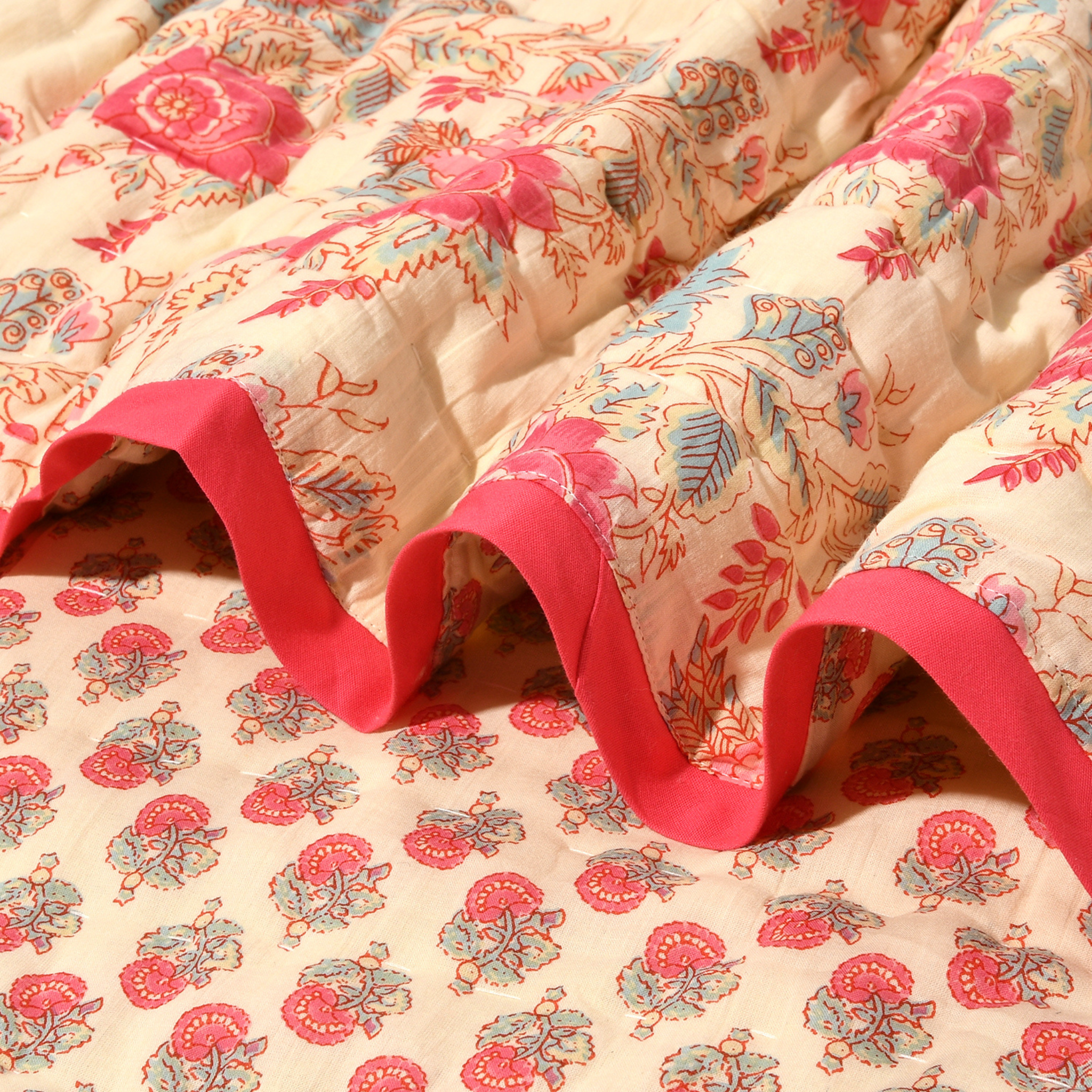 Floral-patterned fabric with red trim on a wooden surface