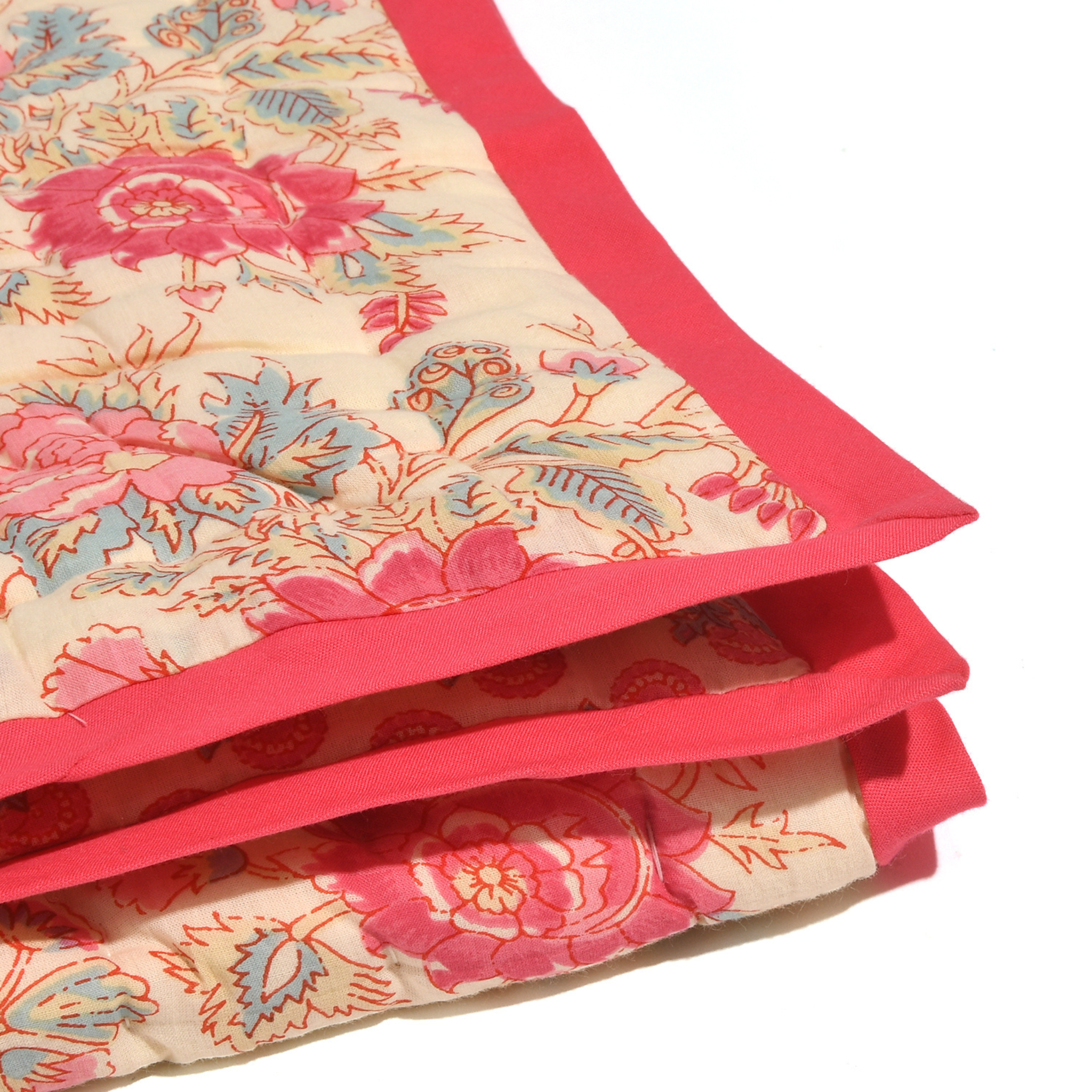Stack of floral-patterned cushions with a red border on a white background