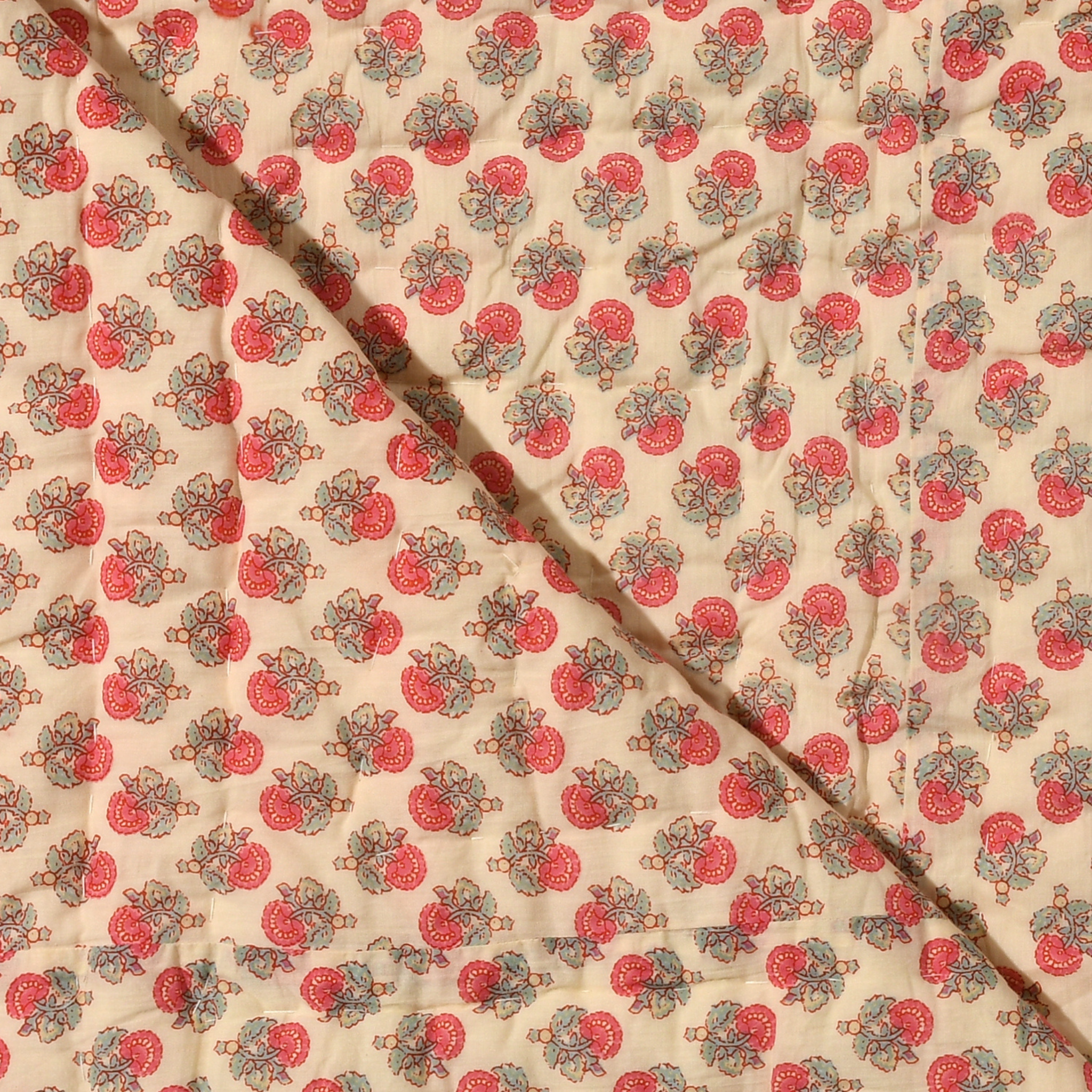 Fabric with a red and green pattern on a beige background