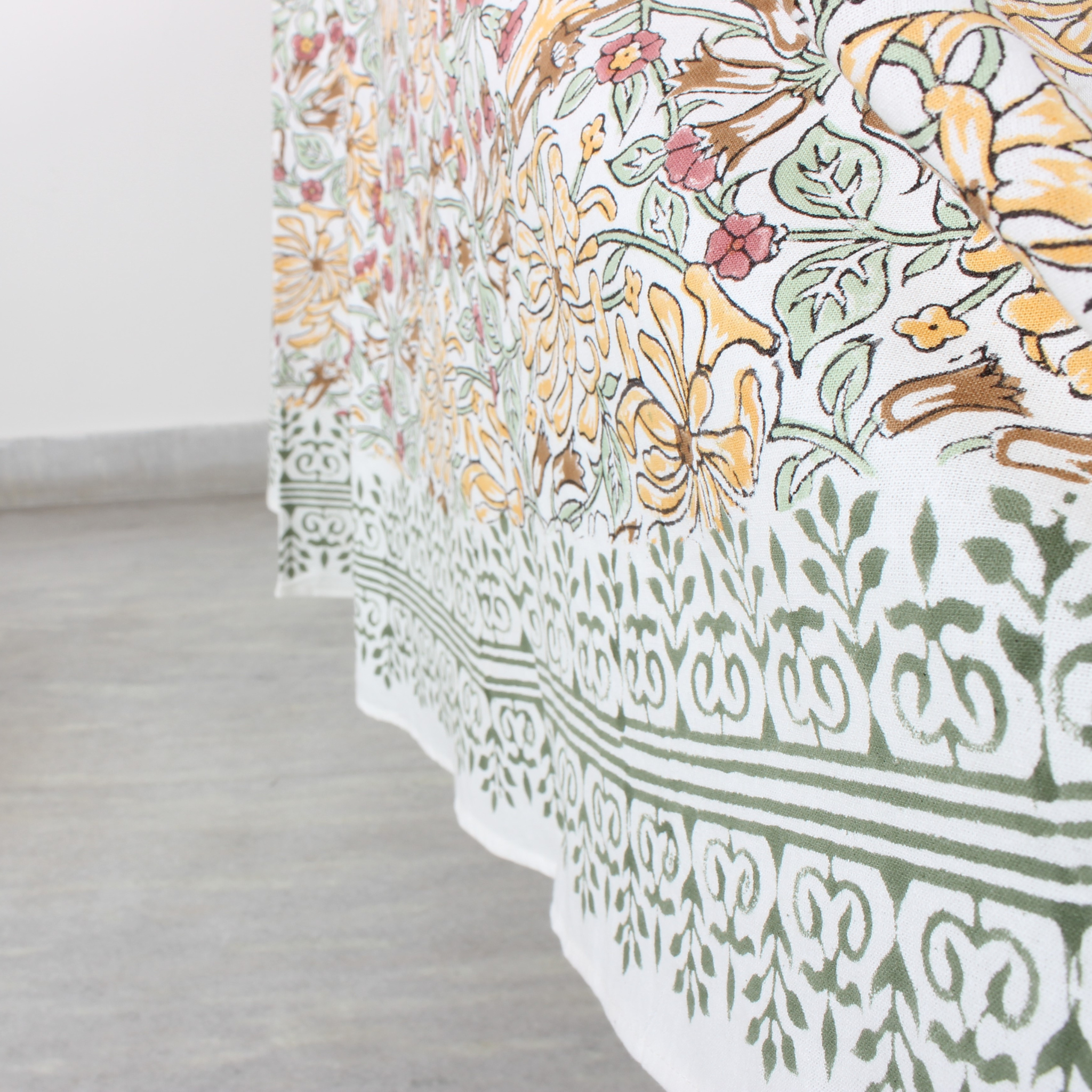 Floral and geometric patterned fabric on a light wooden floor