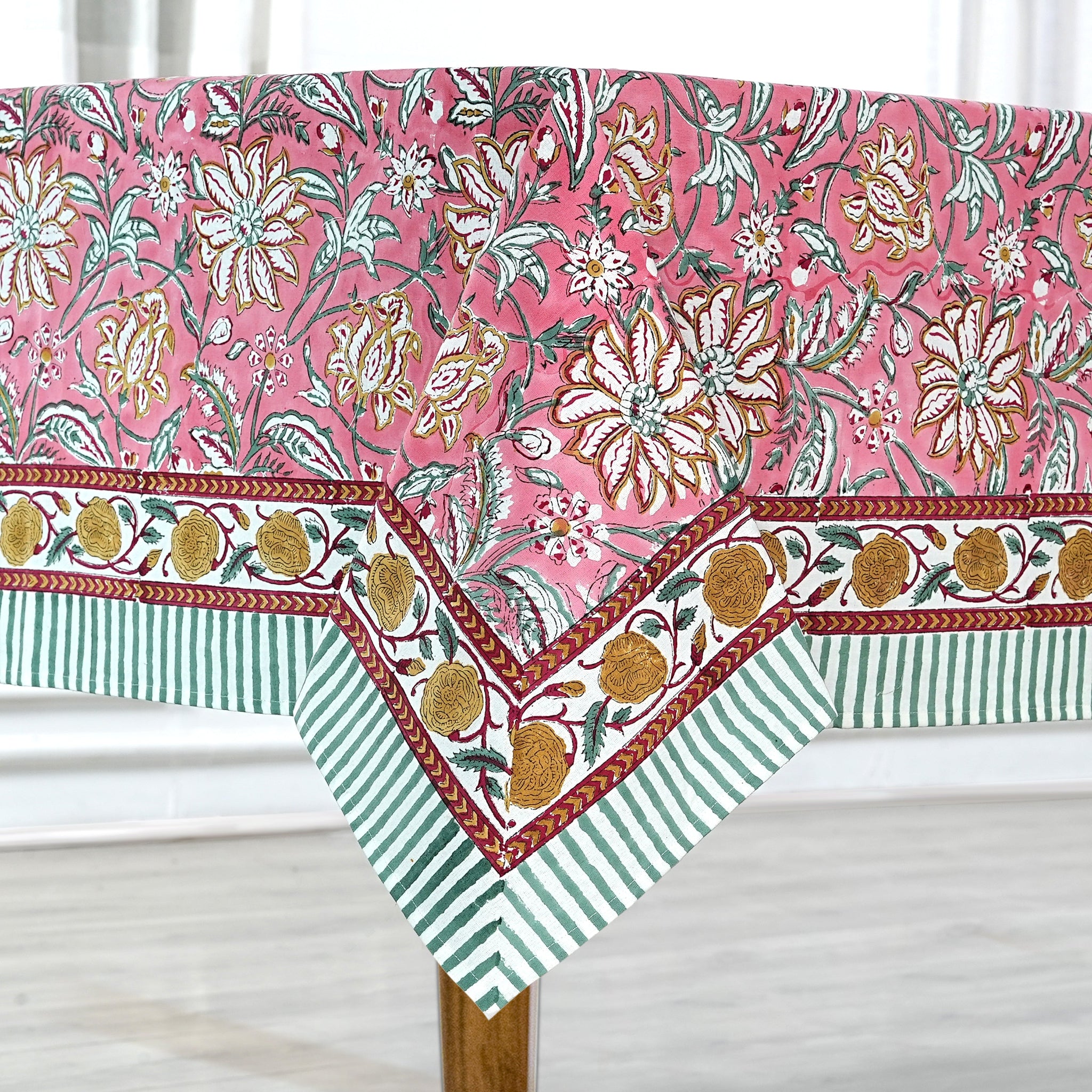 Floral and striped tablecloth on a wooden table