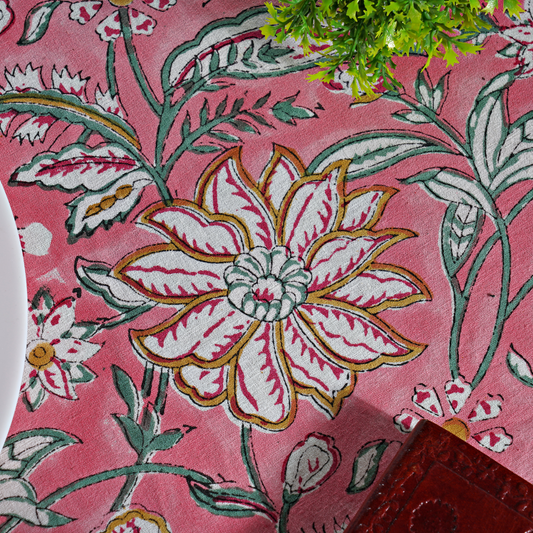Floral patterned fabric with a prominent flower design on a pink background