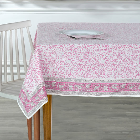 Tablecloth with pink and white floral pattern on a wooden table