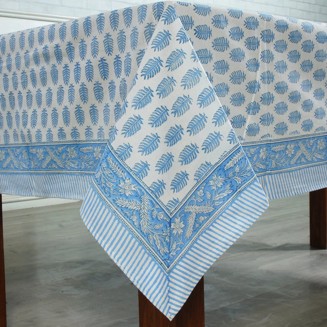 Blue and white patterned tablecloth on a wooden table