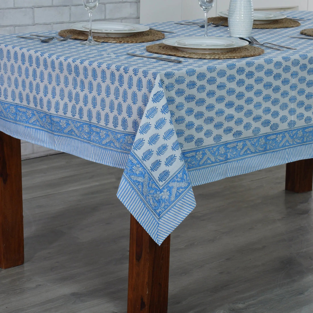 Tablecloth with blue floral pattern on a wooden table