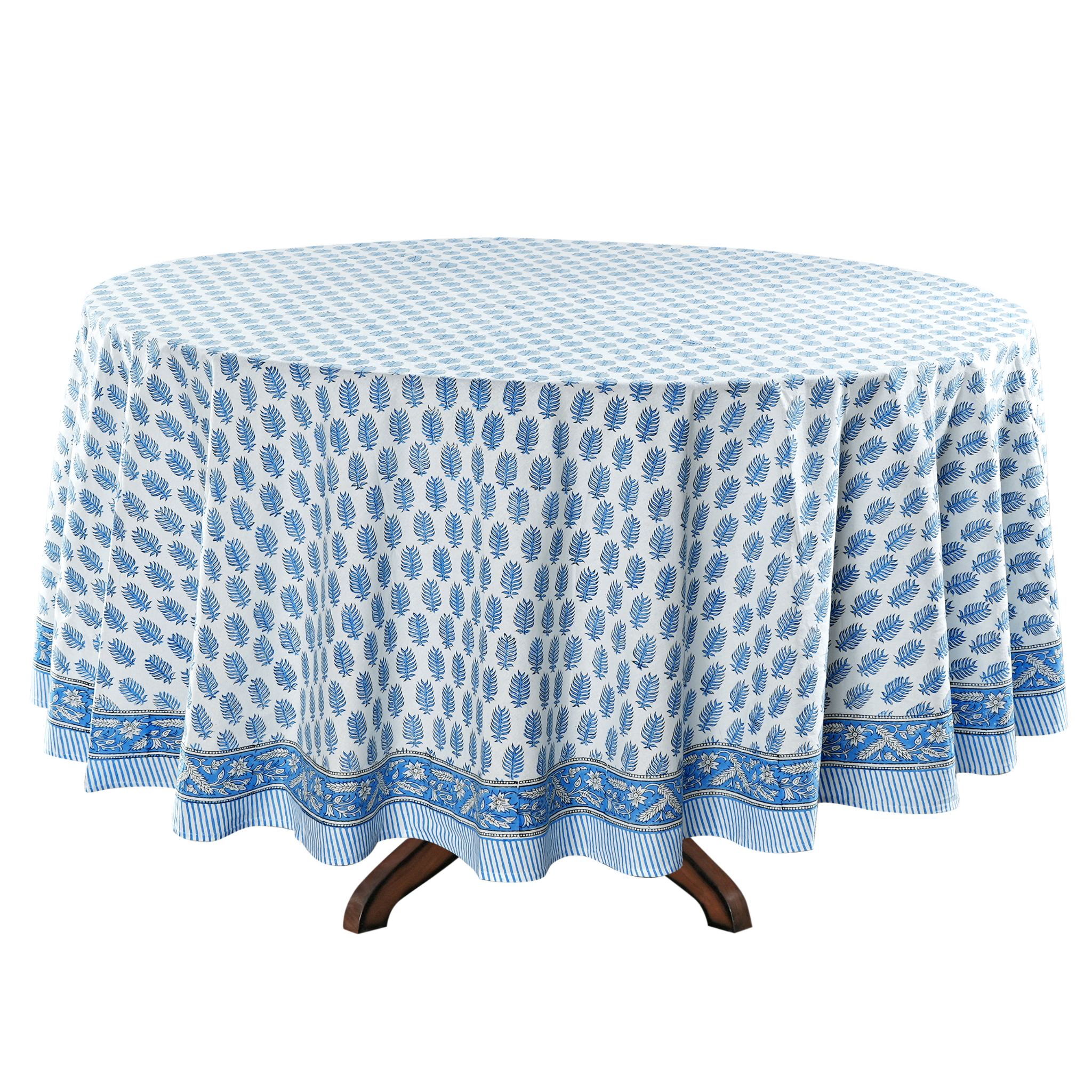 Round table with a blue and white patterned tablecloth on a white background