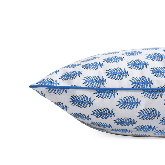 Decorative pillow with blue leaf pattern on a white background