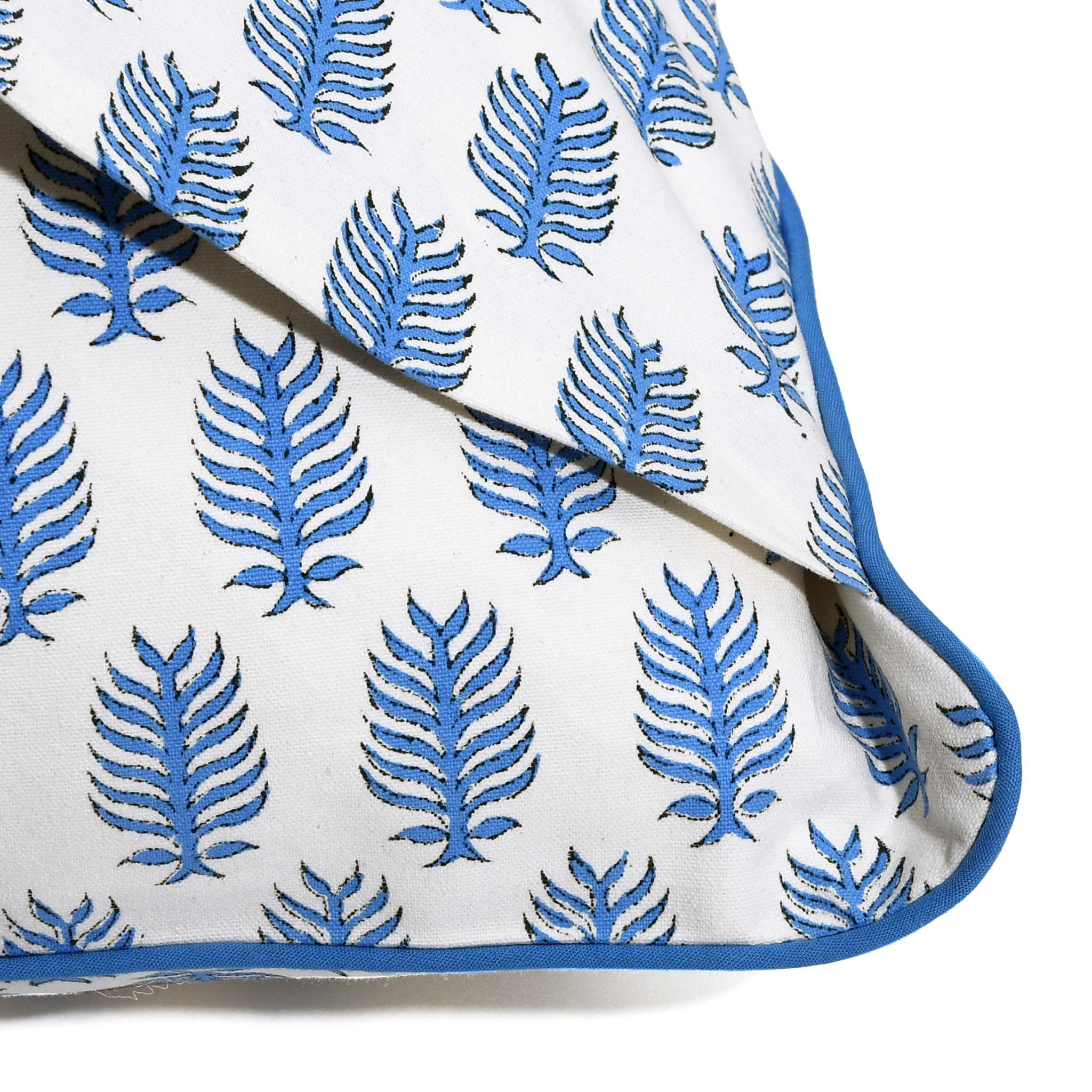 White fabric with blue leaf pattern on a white background