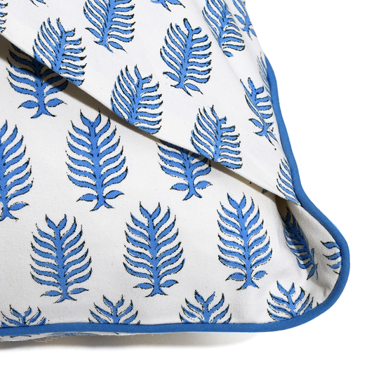 White fabric with blue leaf pattern on a white background
