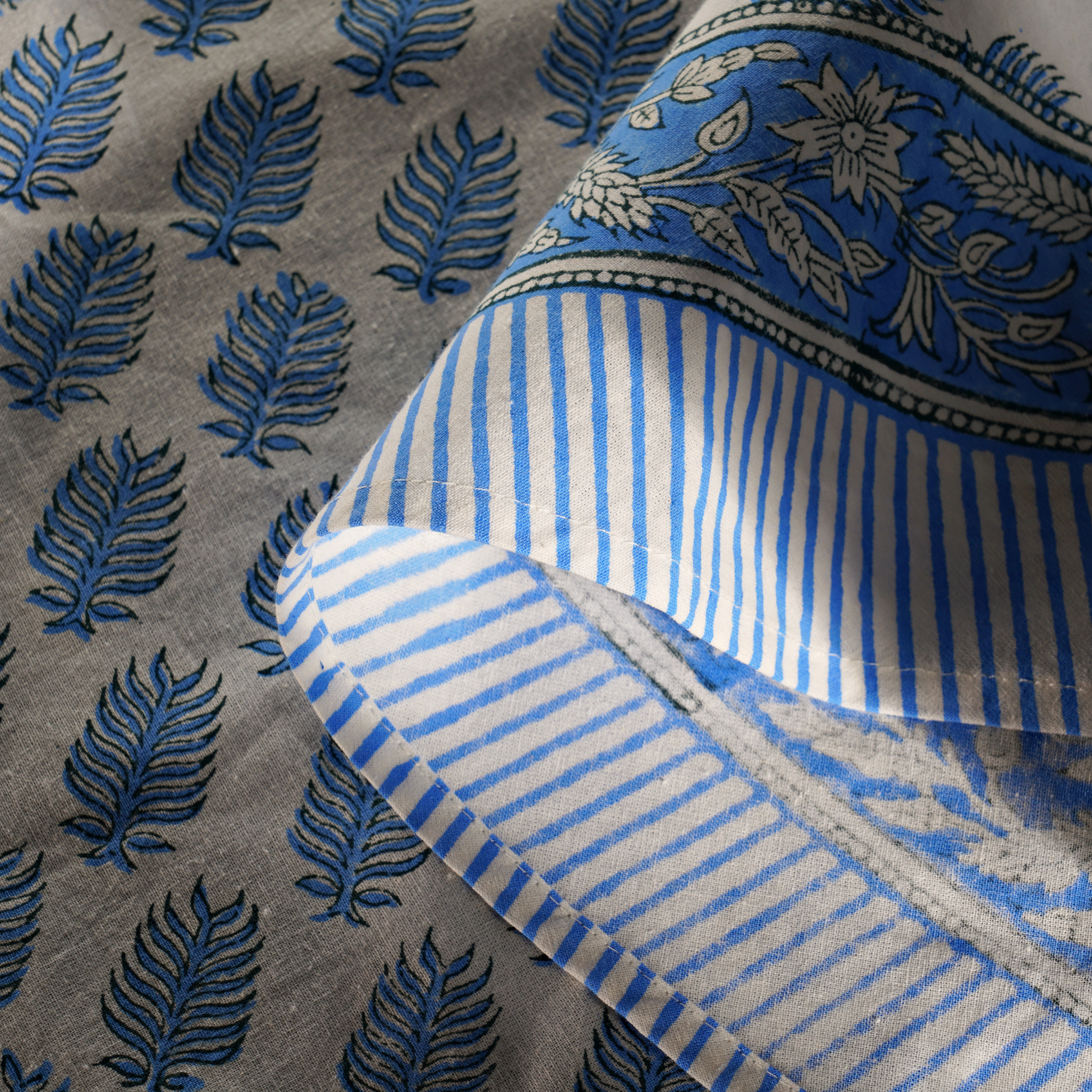 Textile with blue leaf patterns on a gray background