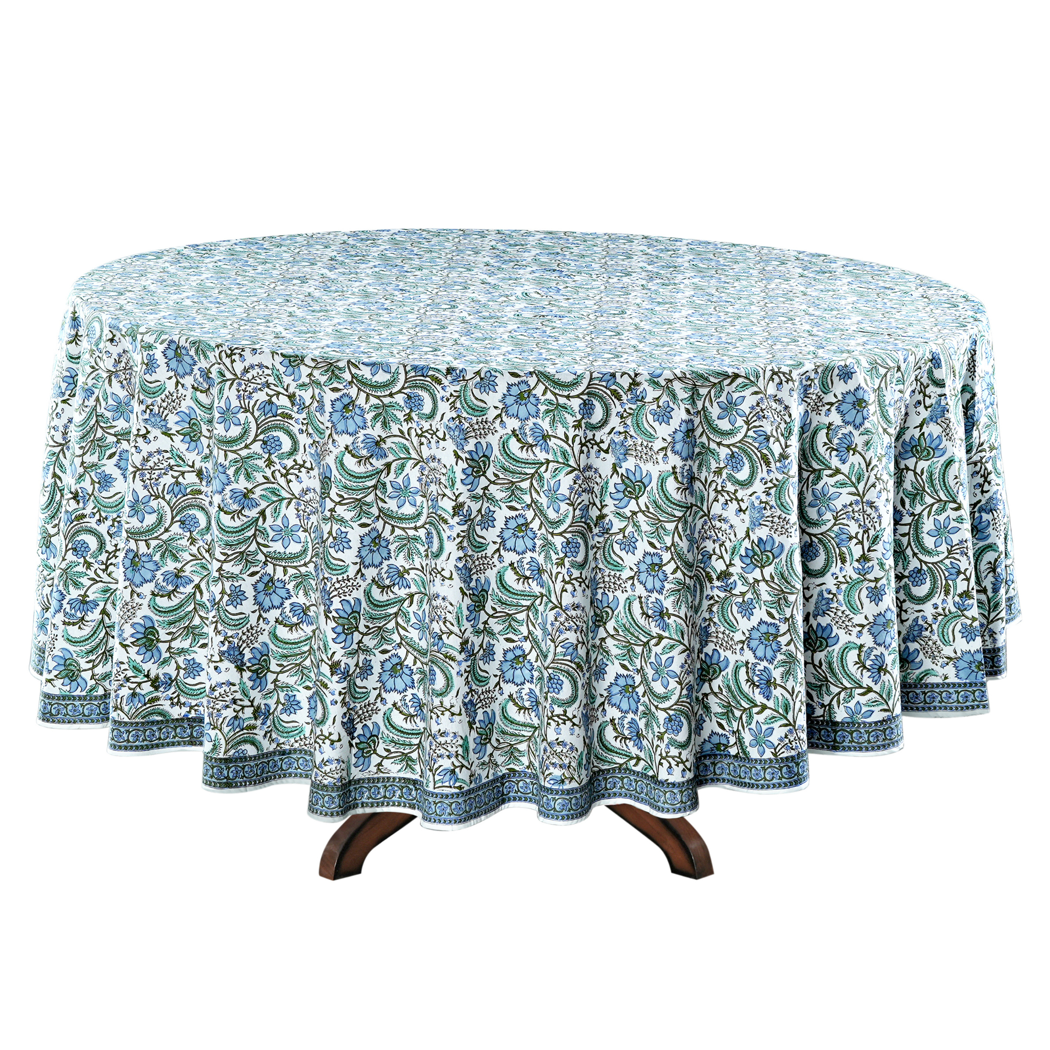 Round table with a floral patterned tablecloth on a white background