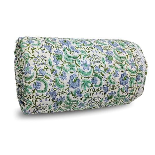 Rolled-up floral blanket with blue and green pattern on a white background