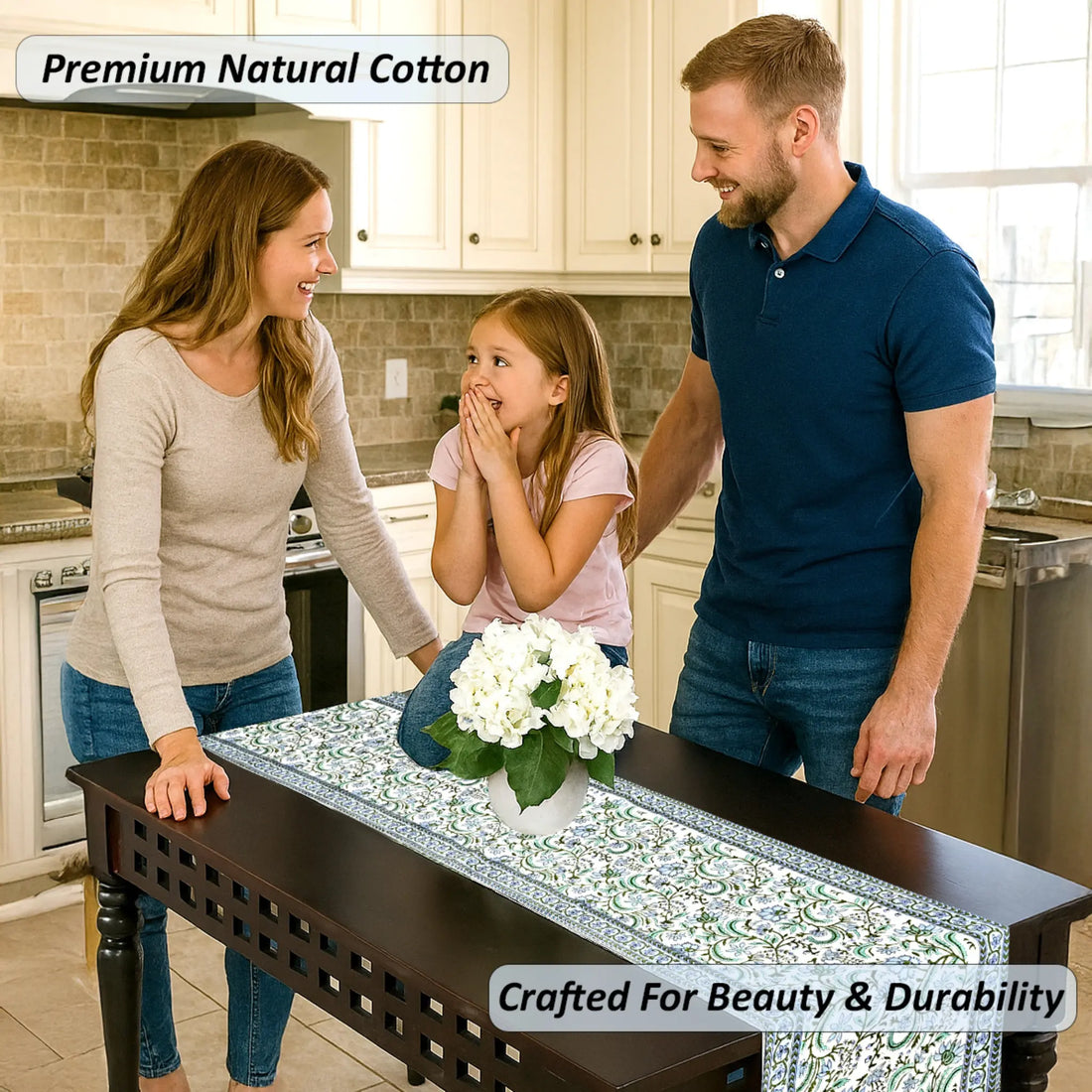 Family in a kitchen with a table runner featuring white flowers.