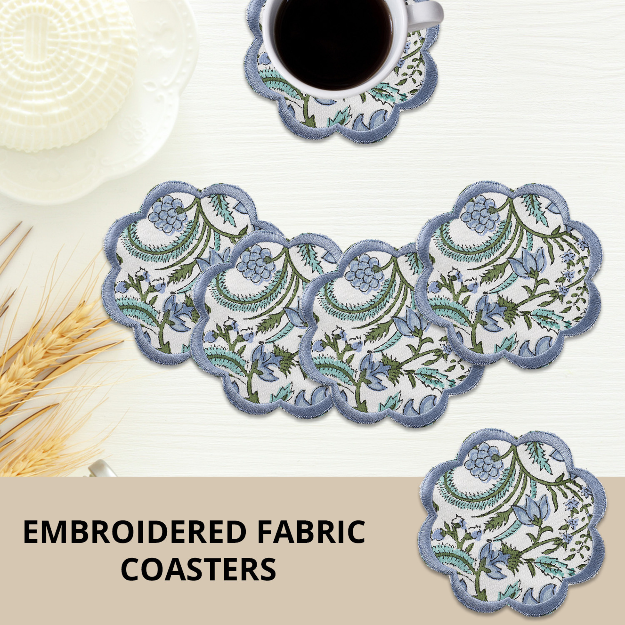 Set of embroidered fabric coasters with a cup of coffee on a white surface.