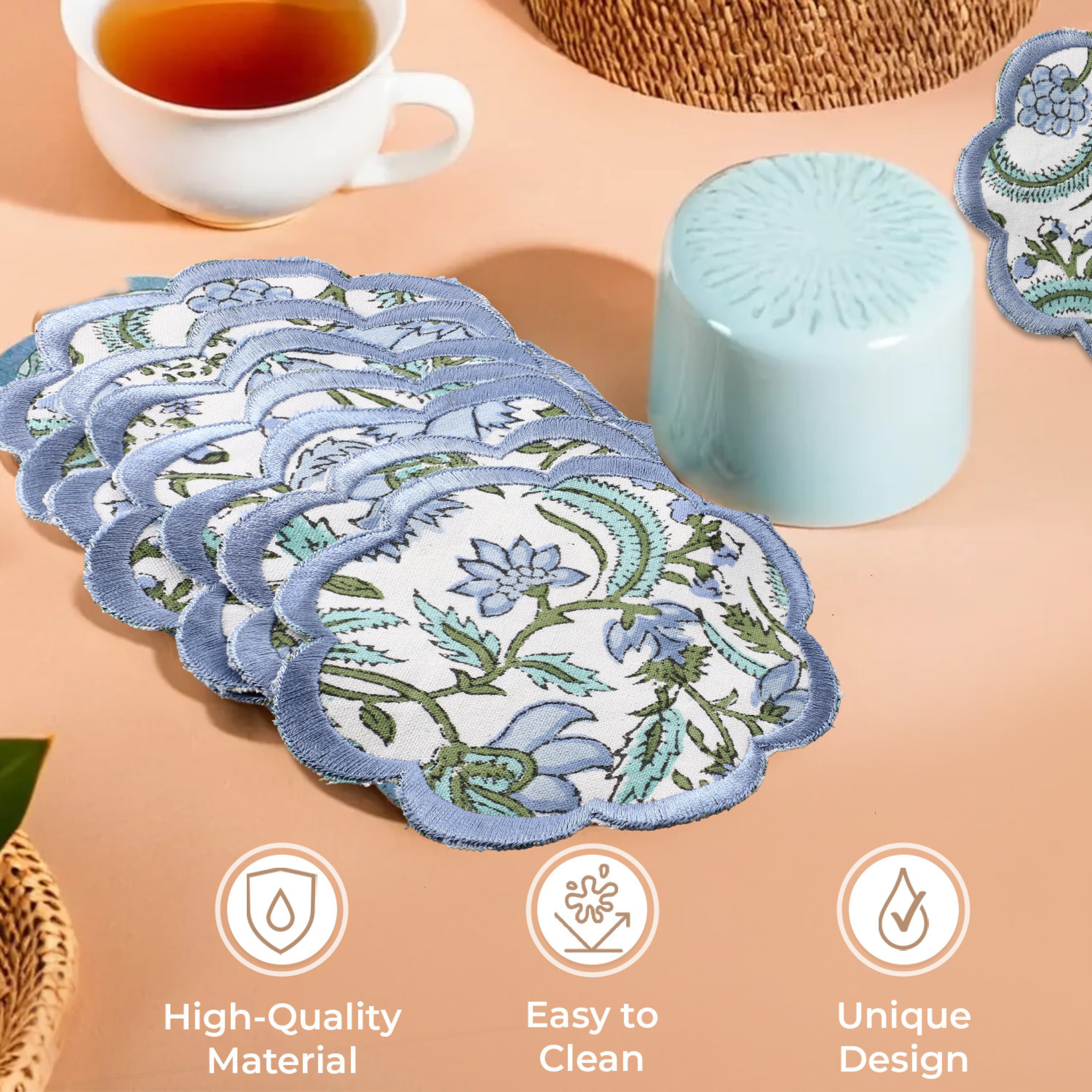 Set of floral coasters on a table with tea and a candle, featuring icons for high-quality material, easy to clean, and unique design.