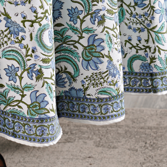 Close-up of floral patterned fabric with blue and green colors on a neutral background