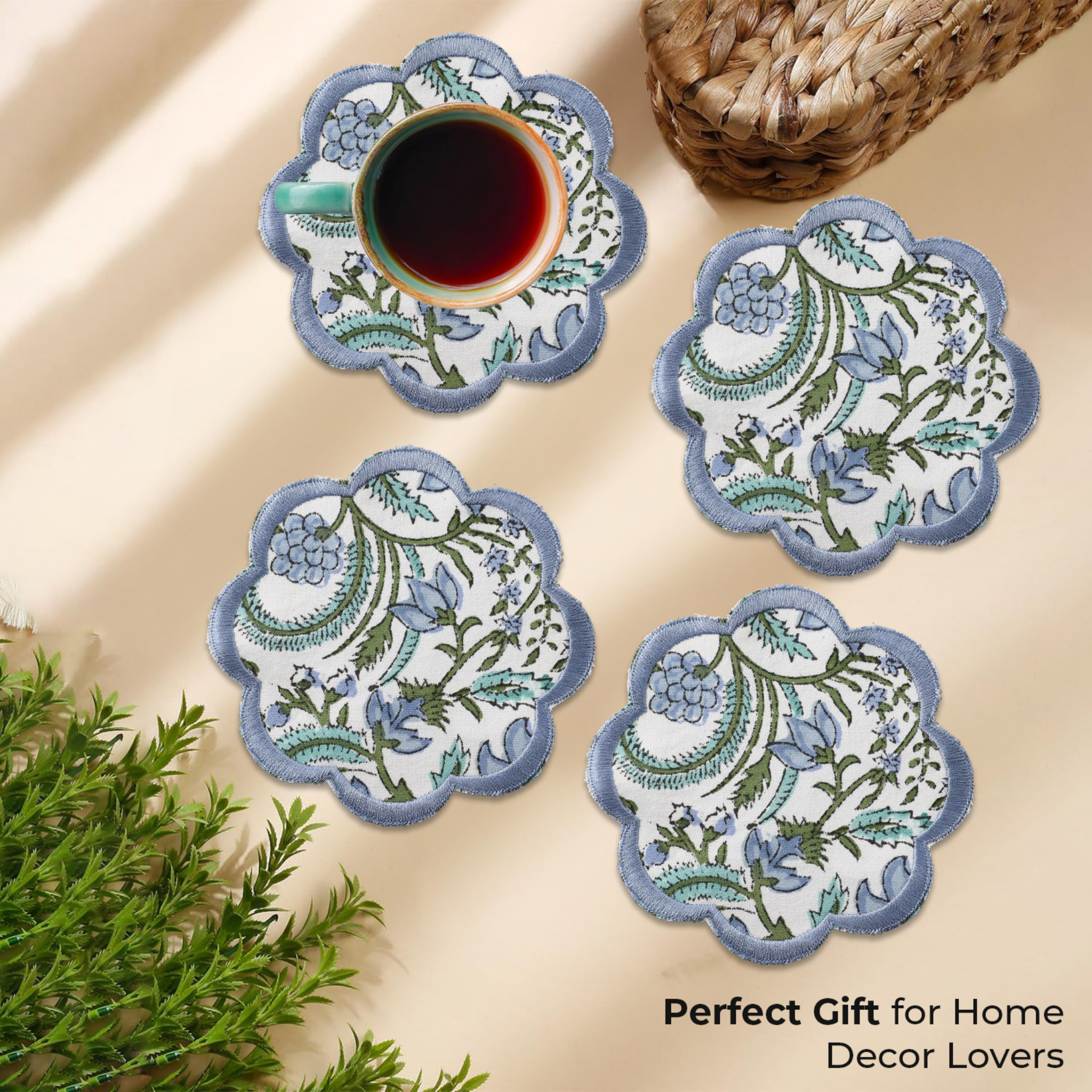 Set of four decorative coasters with floral patterns on a beige surface.