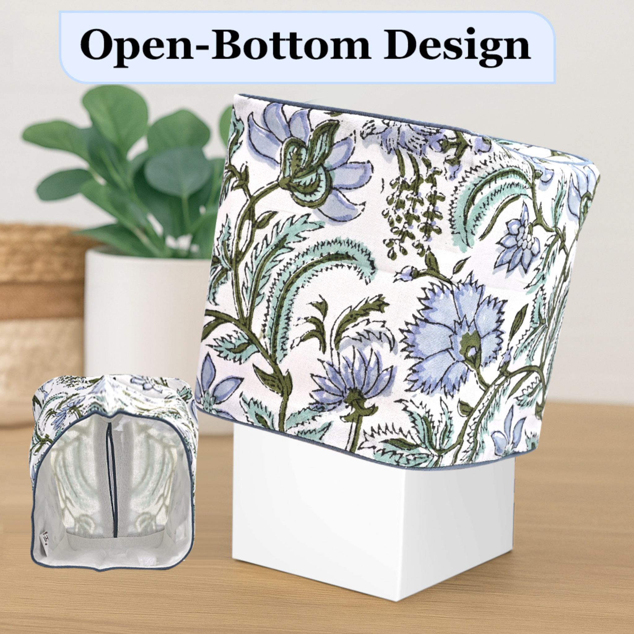 Floral-patterned container with open-bottom design on a wooden surface.