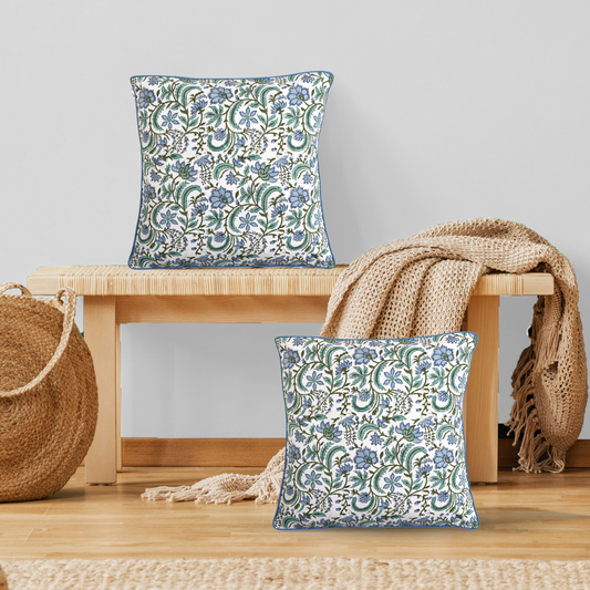 Floral patterned cushions on a wooden bench with a neutral background
