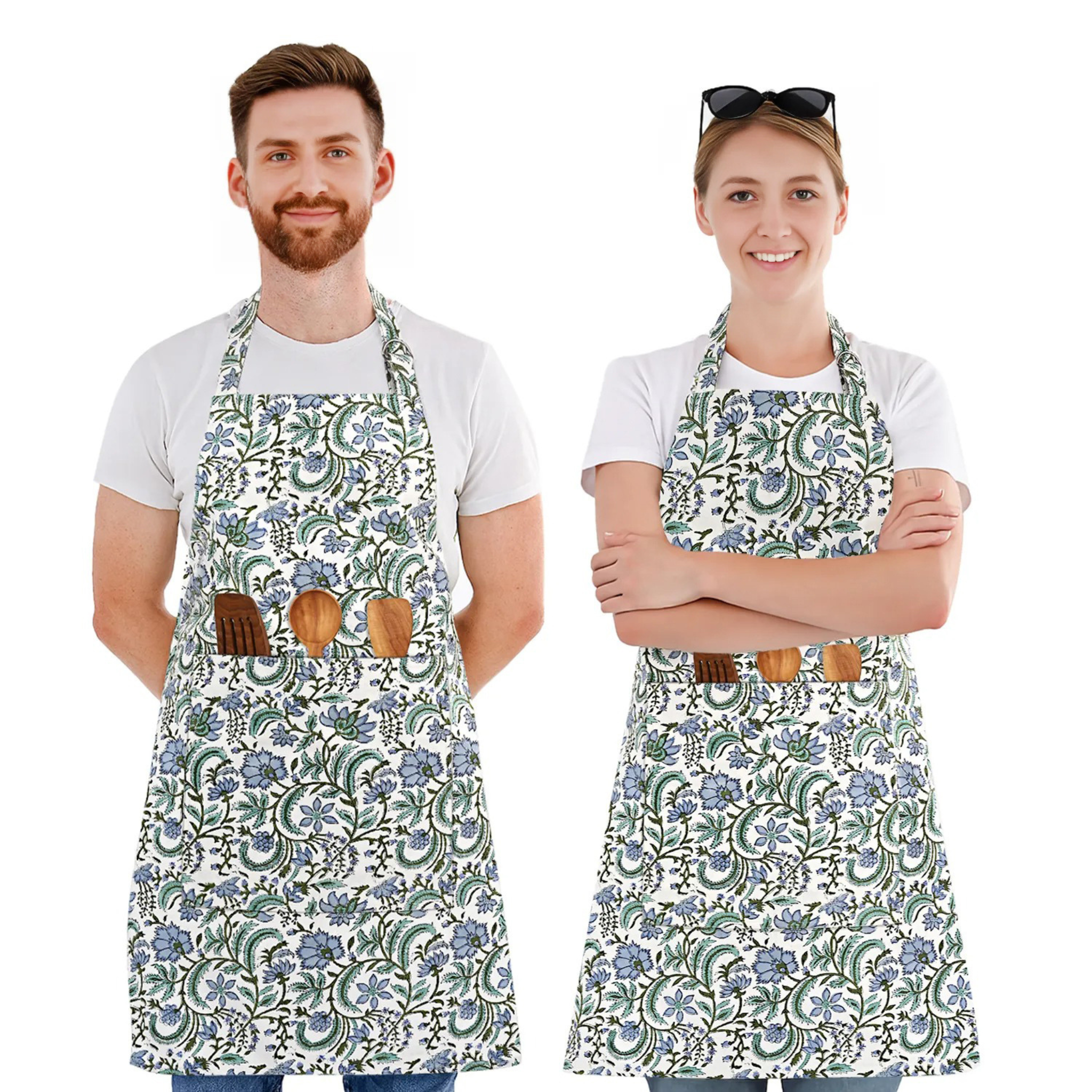 Two people wearing floral aprons with wooden tool holders on a white background
