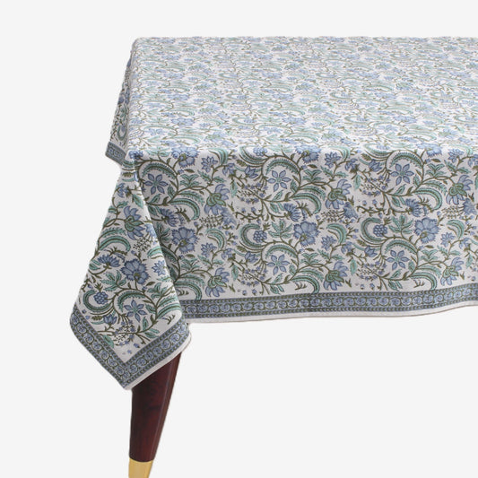 Floral patterned tablecloth on a table with a white background
