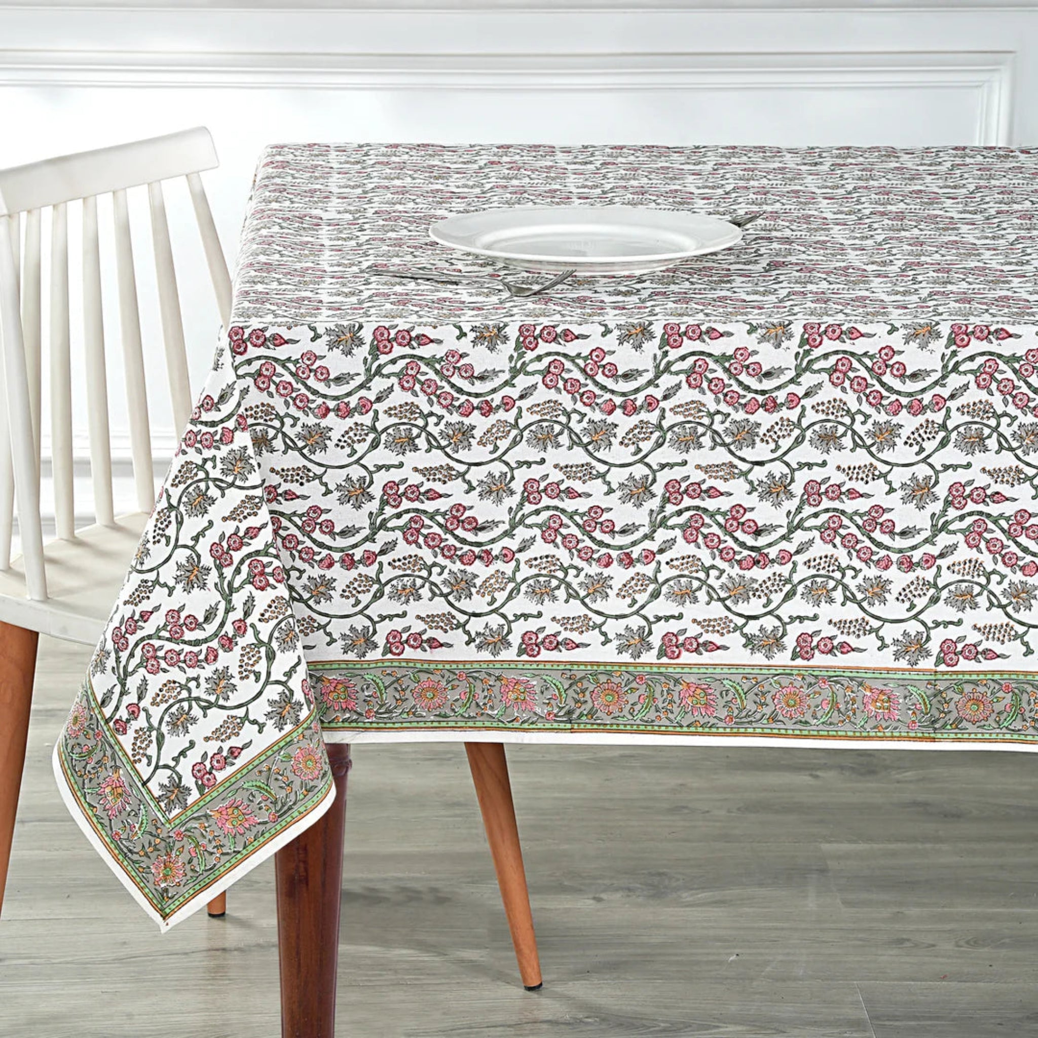 Decorative tablecloth with floral pattern on a wooden table
