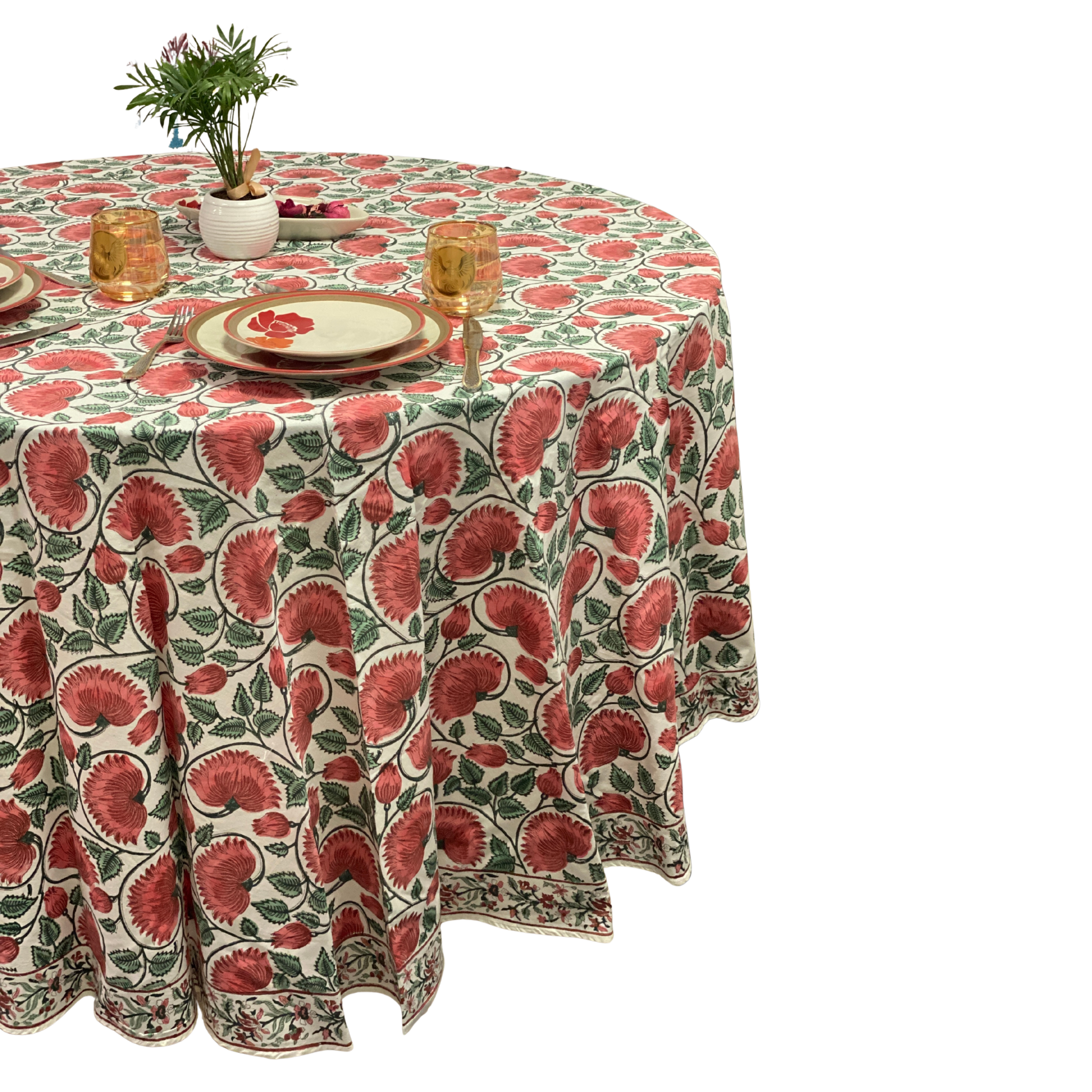 Round table with a floral patterned tablecloth on a white background