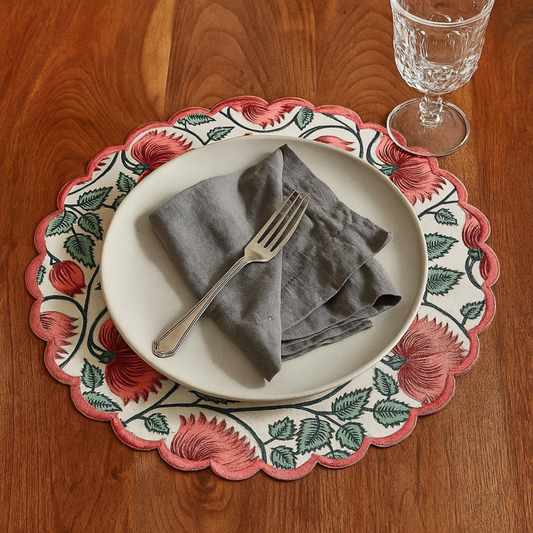 Plated dinner setting with a decorative placemat on a wooden table