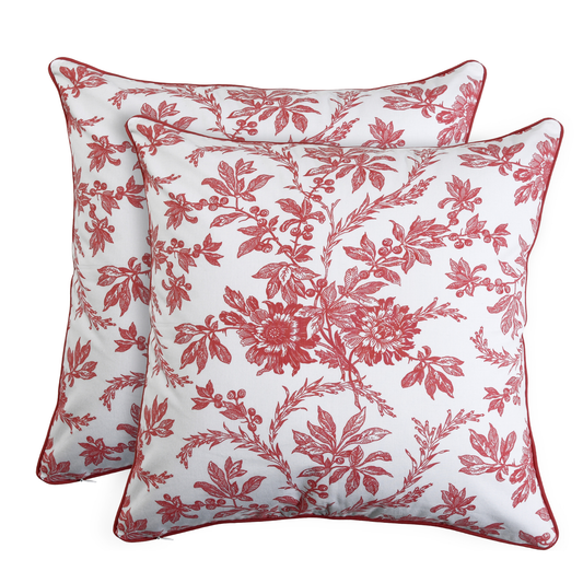 Two red floral-patterned pillows on a white background