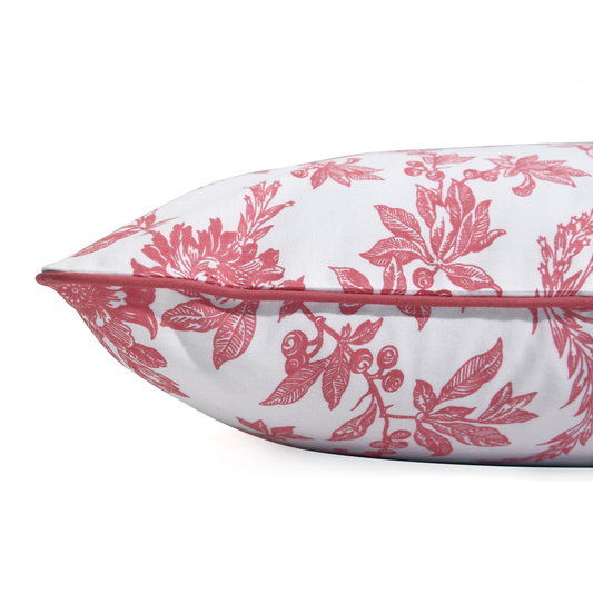 Floral-patterned pillow with pink design on a white background