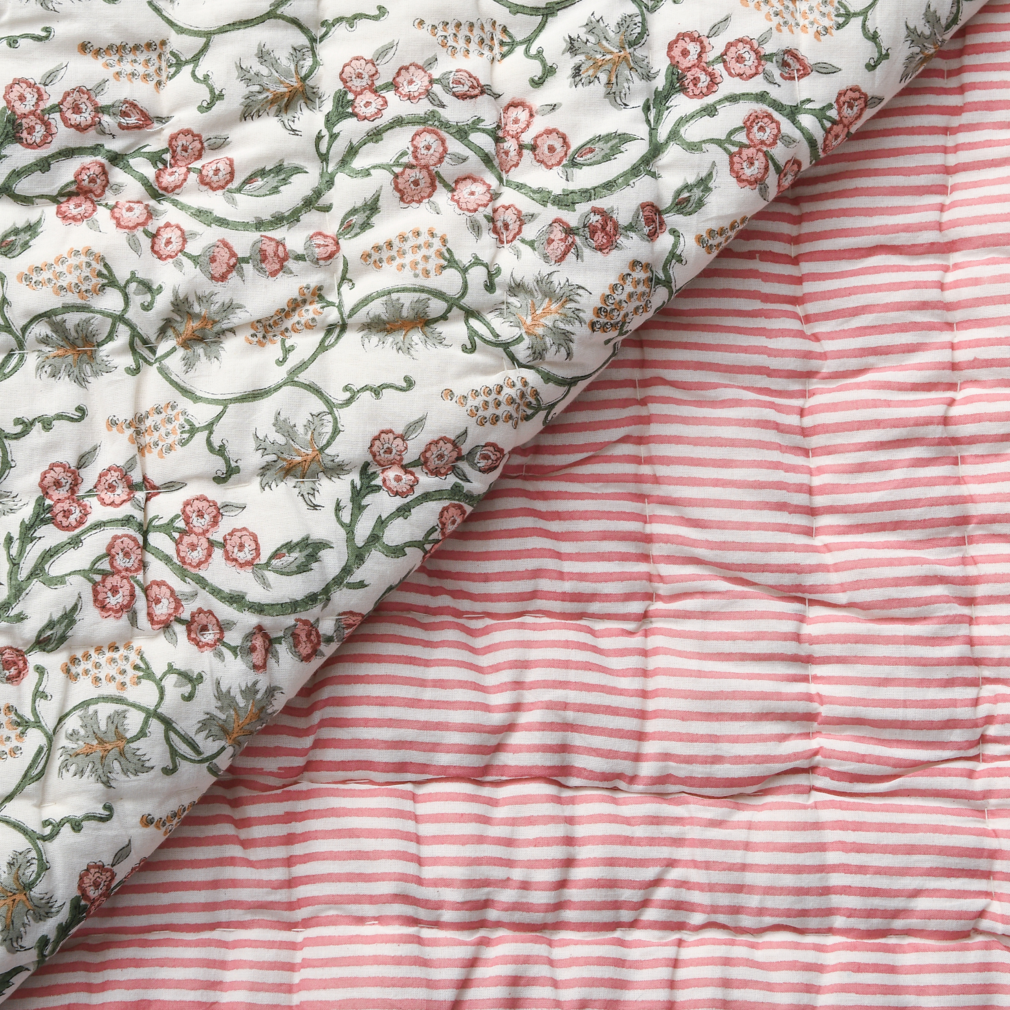 Floral-patterned fabric on top of a red and white striped fabric