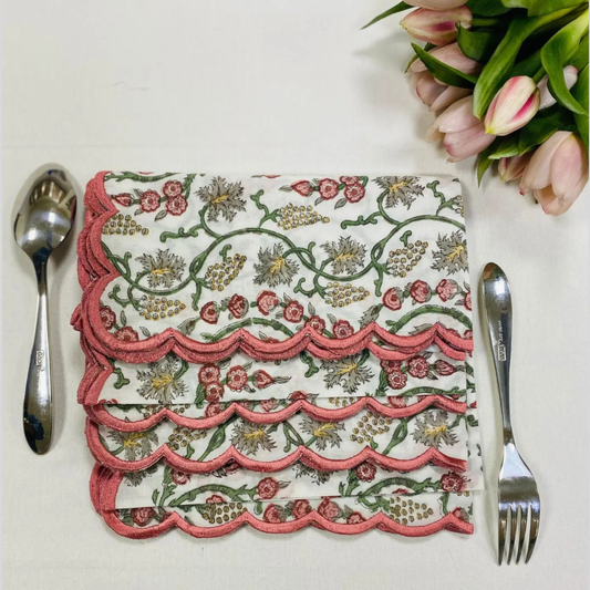 Decorative floral-patterned napkin with cutlery on a white surface