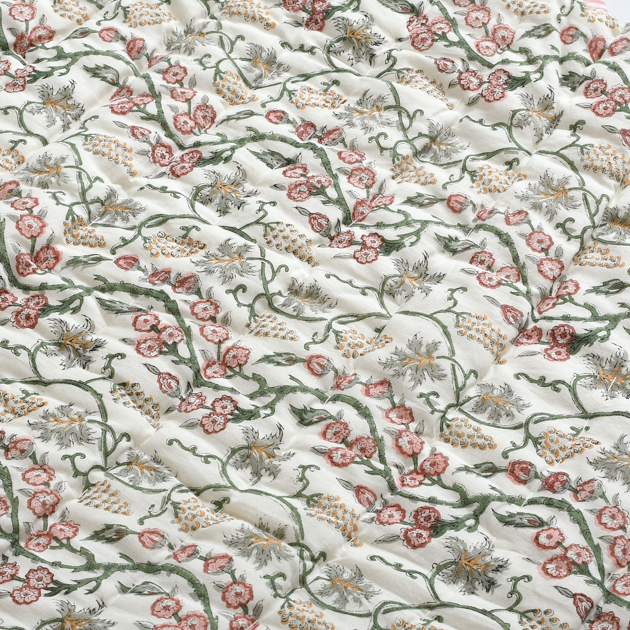 Floral patterned fabric with pink, green, and orange flowers on a white background