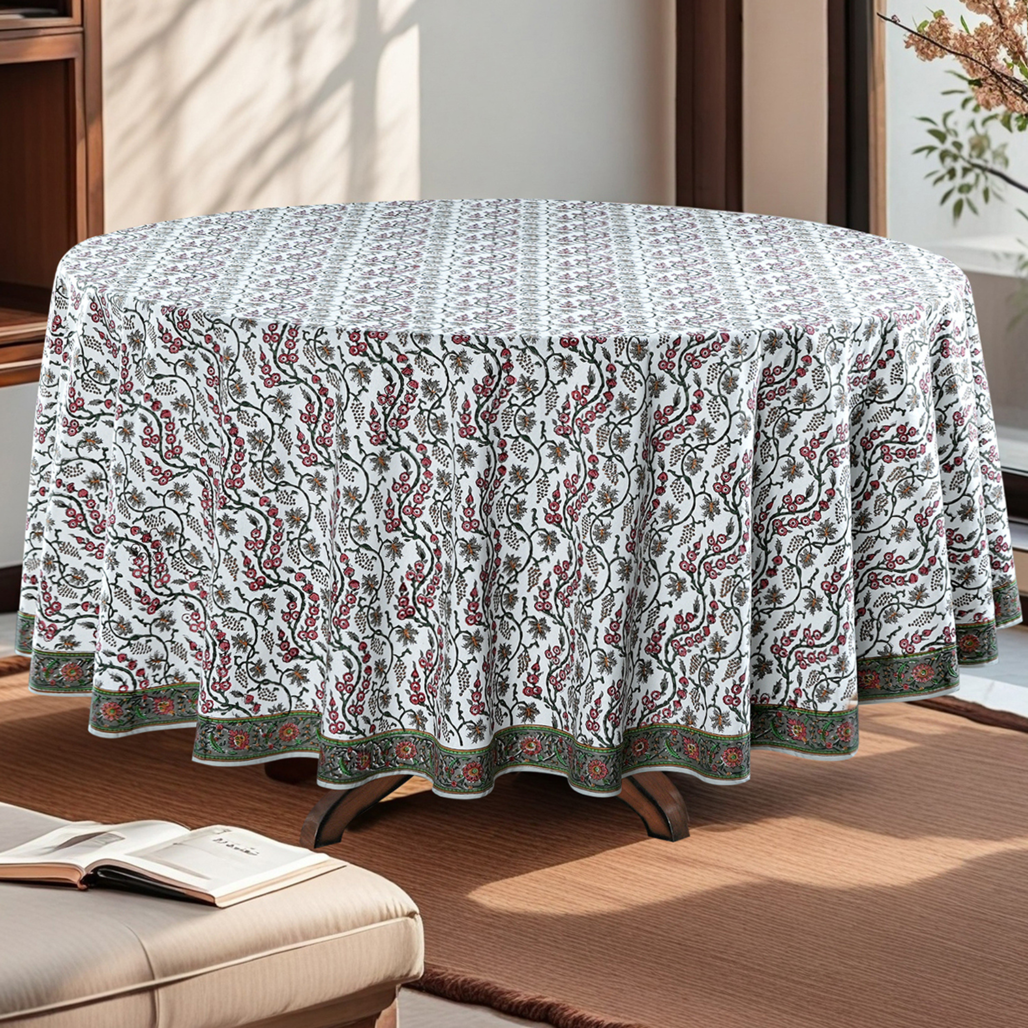 Round table with a patterned tablecloth in a living room setting