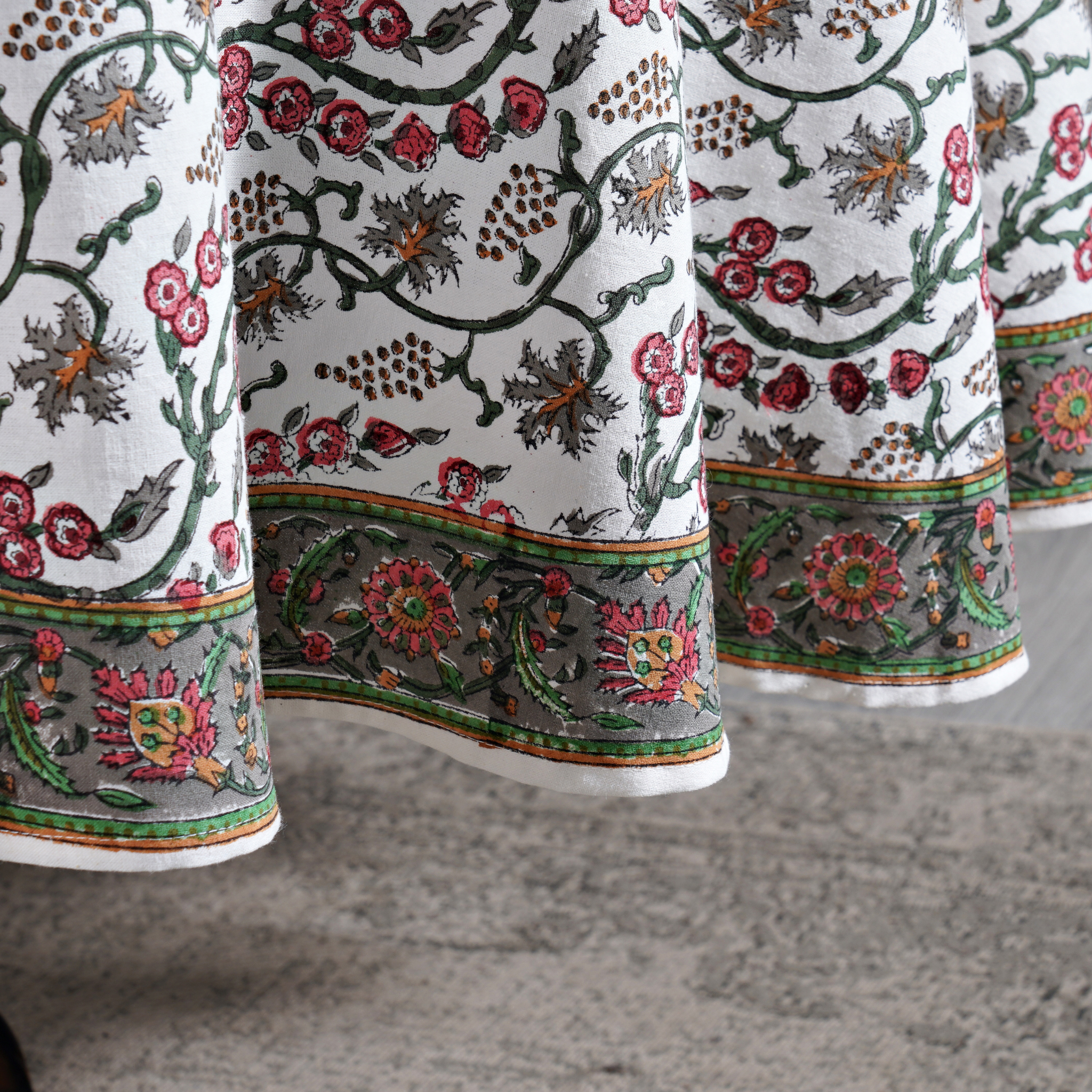 Close-up of embroidered fabric with floral patterns on a neutral background
