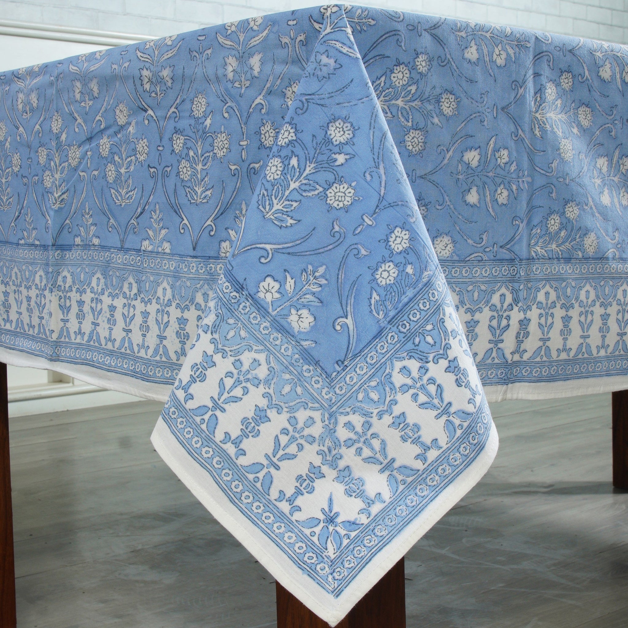 Blue and white patterned tablecloth on a wooden table