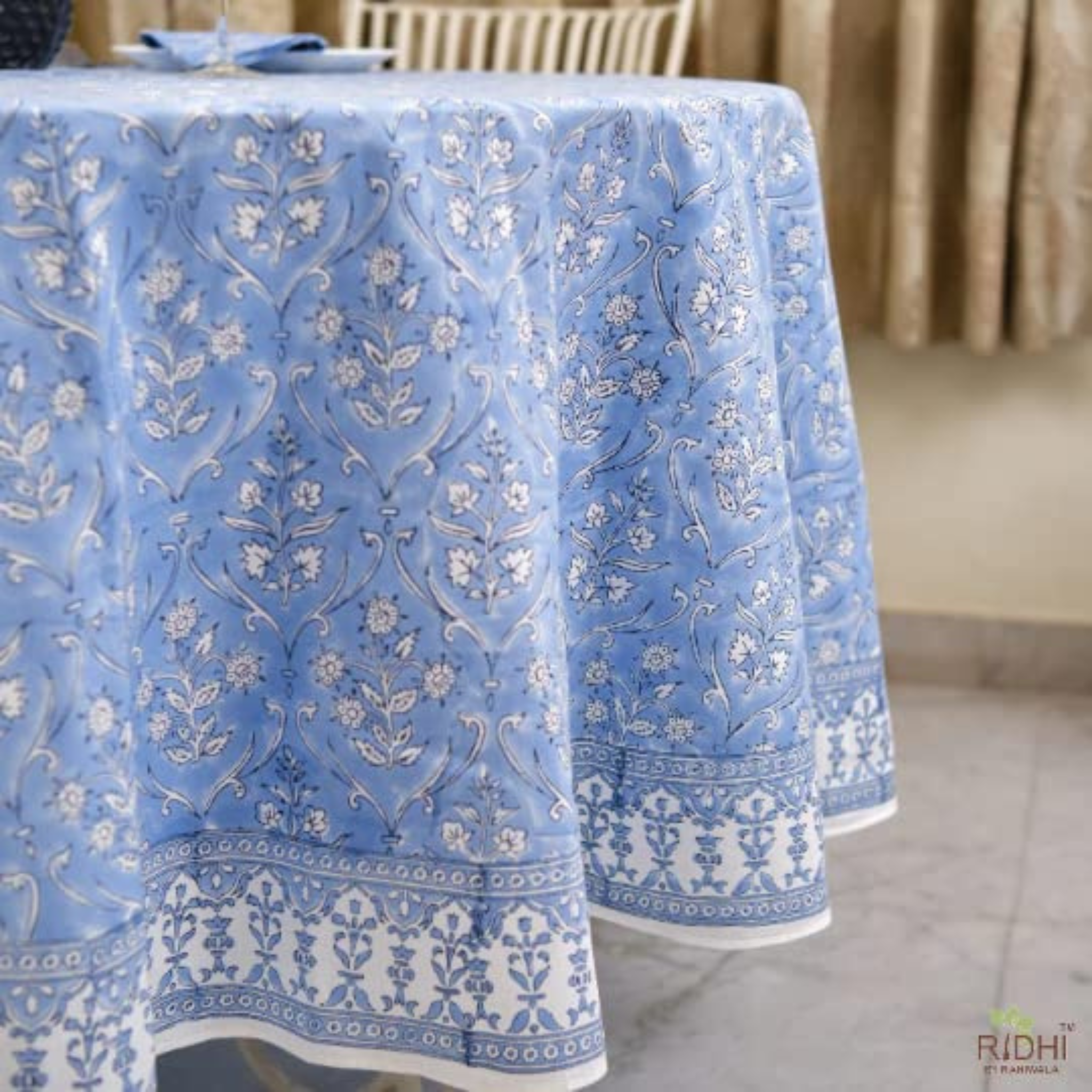 Blue floral patterned tablecloth on a table with a neutral background