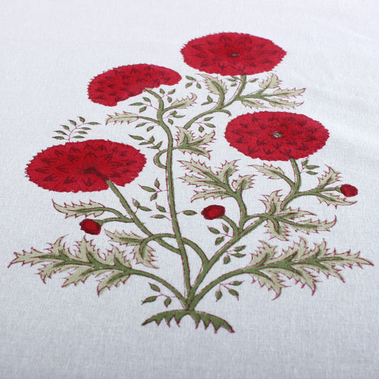 Embroidered design of red flowers on a white fabric background