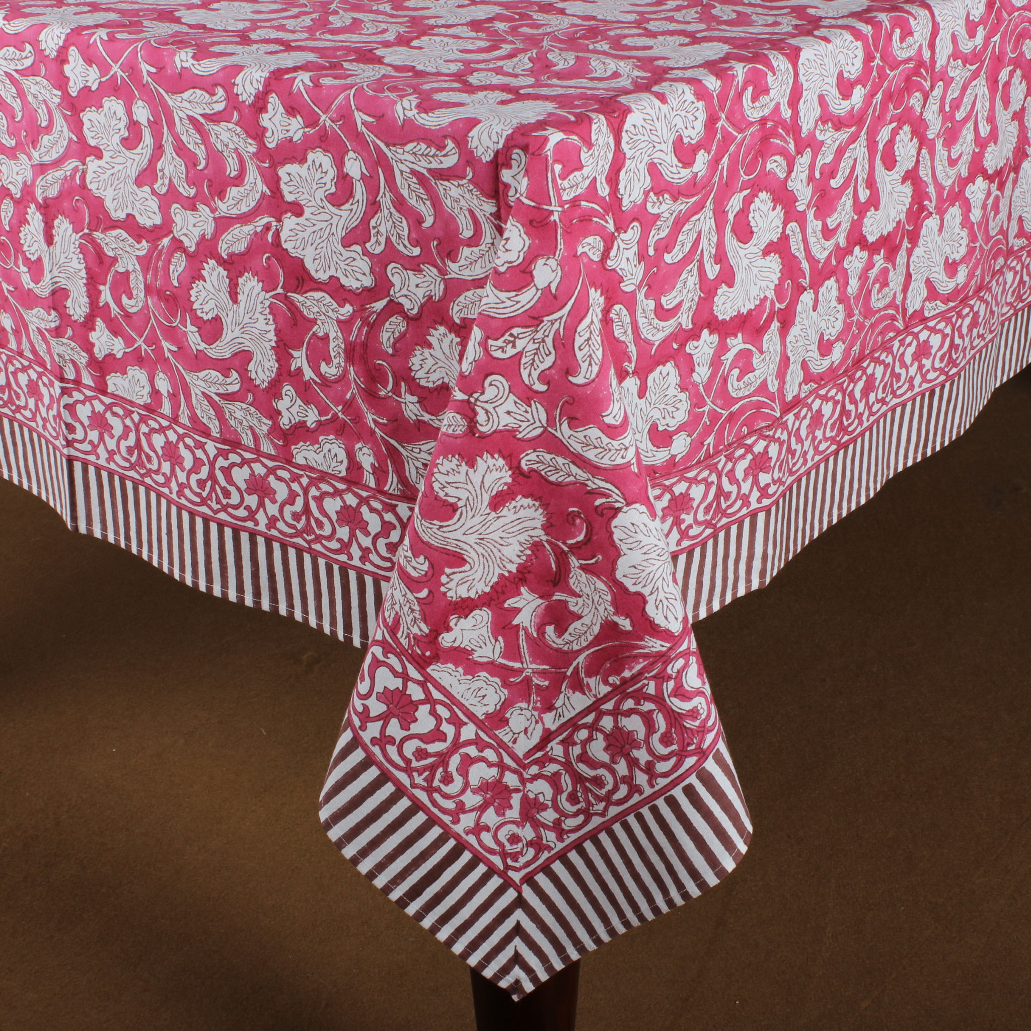 Pink and white patterned tablecloth on a brown background