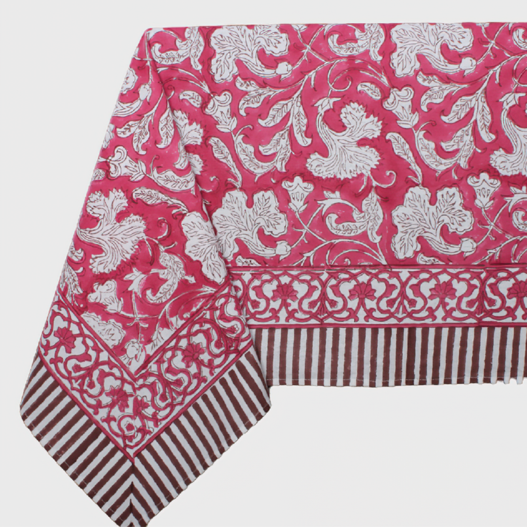 Pink tablecloth with white floral pattern on a white background