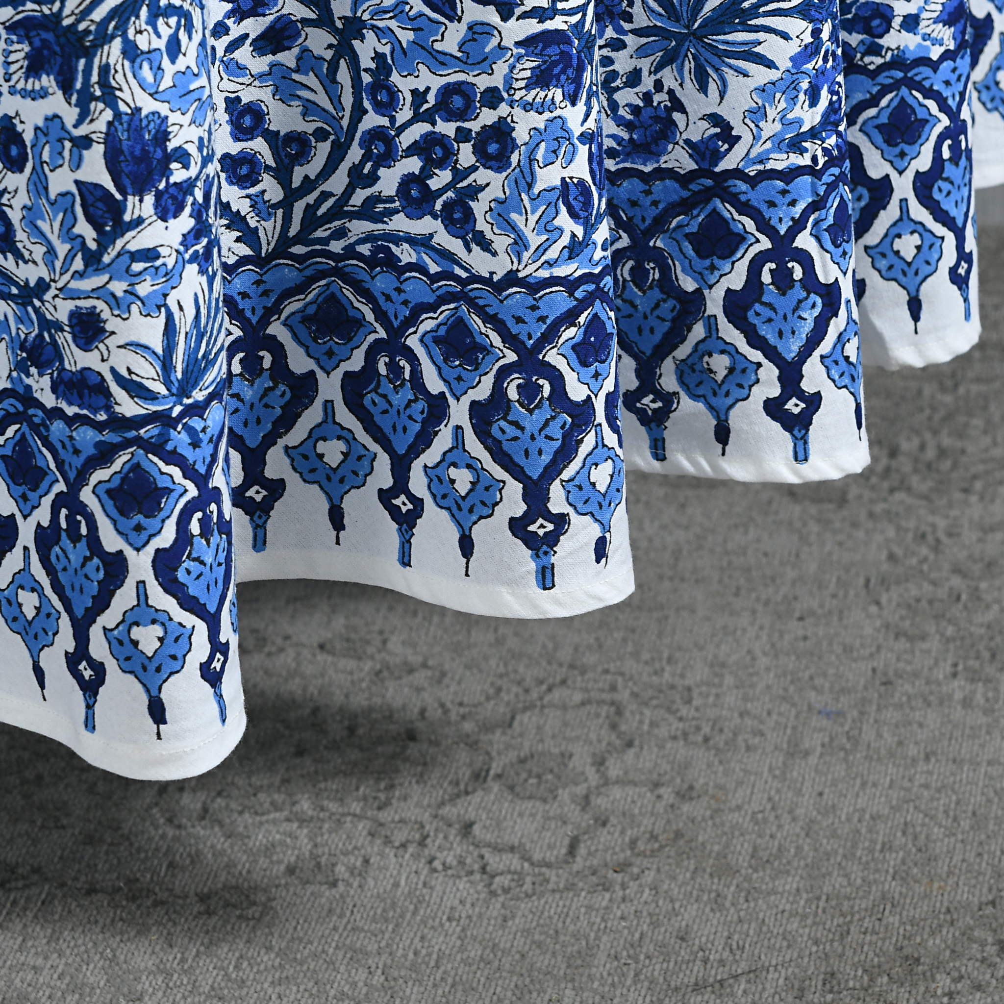 Close-up of blue and white patterned fabric on a textured surface