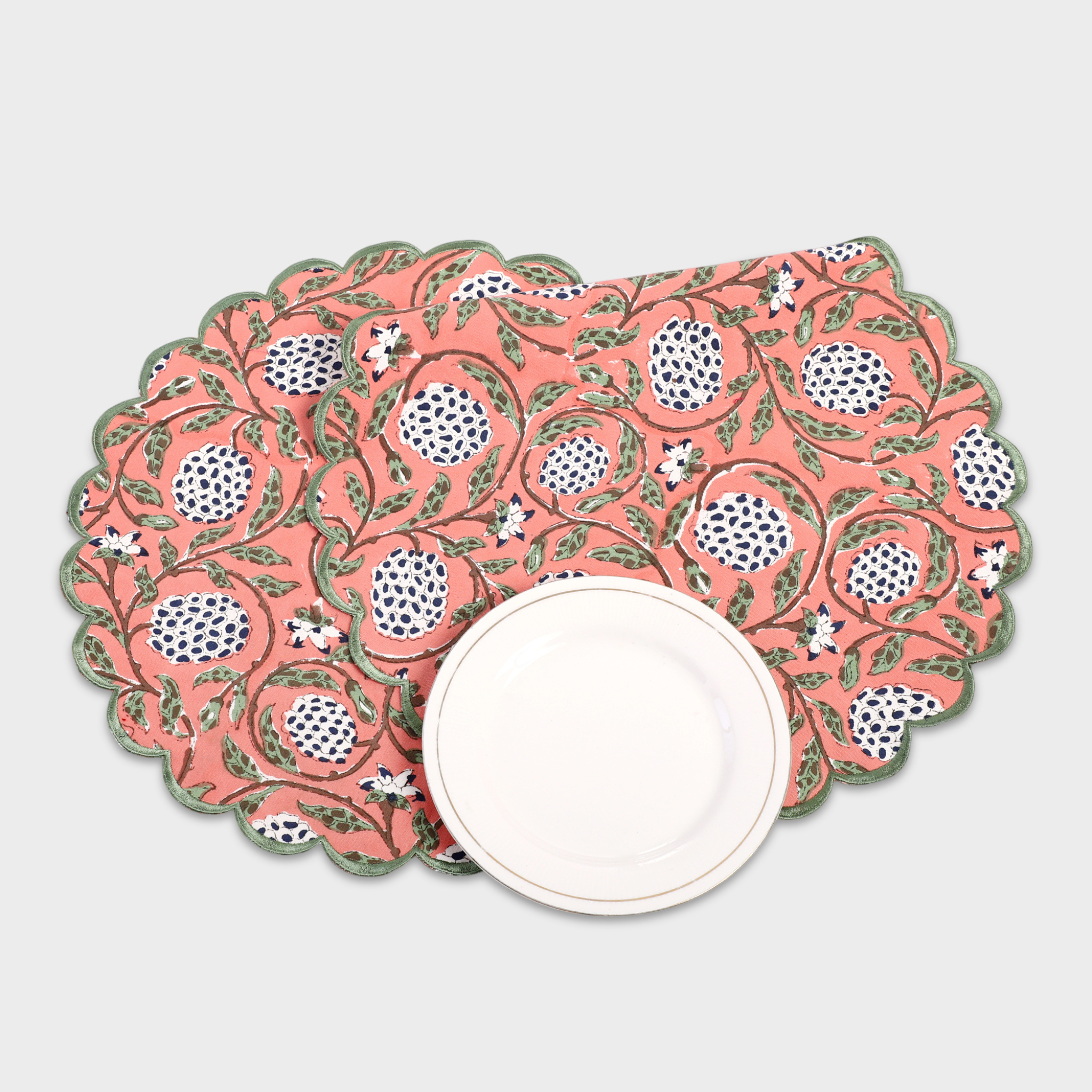 Decorative placemat with pomegranate pattern on a white surface