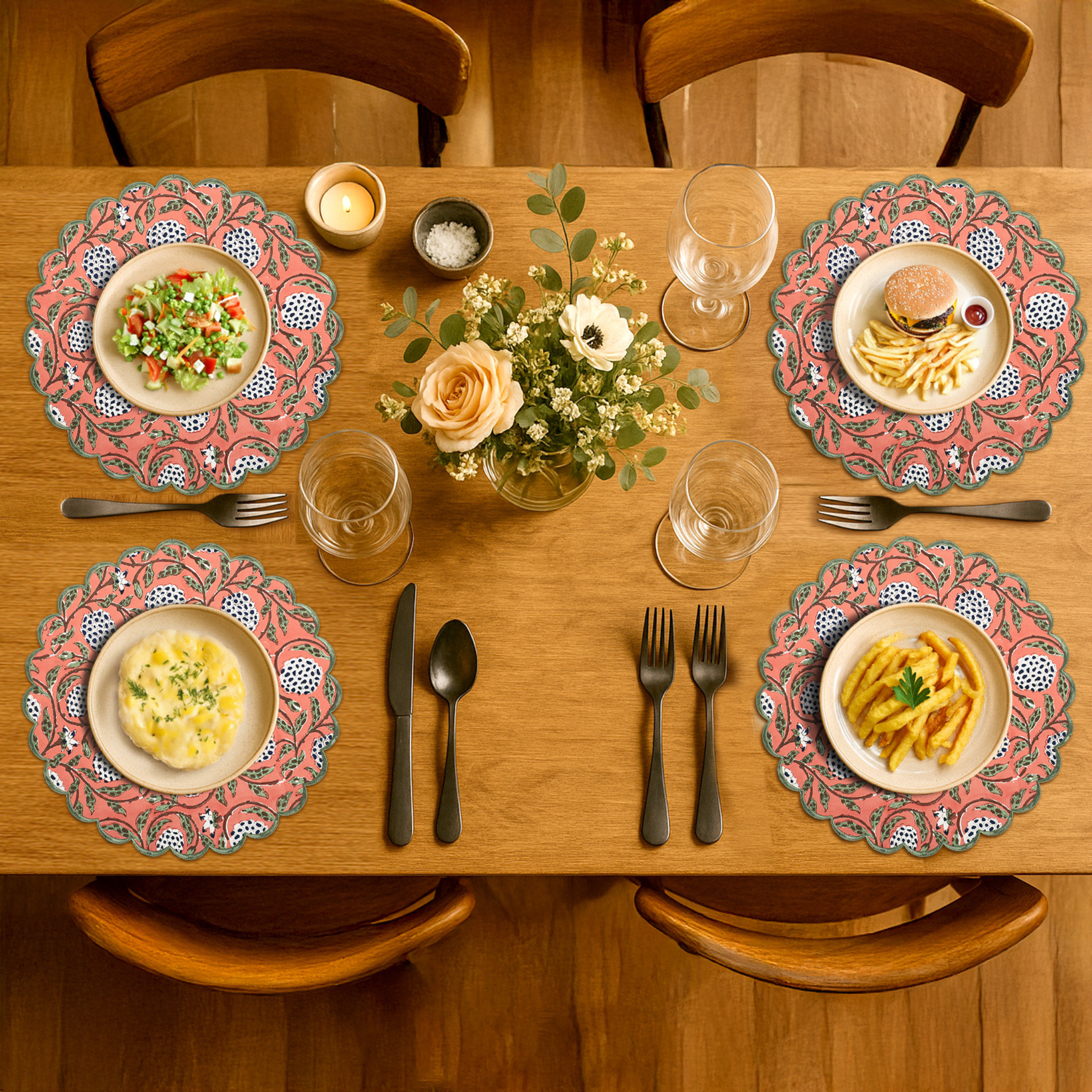 Dining table set with plates, cutlery, and a centerpiece on a wooden table.